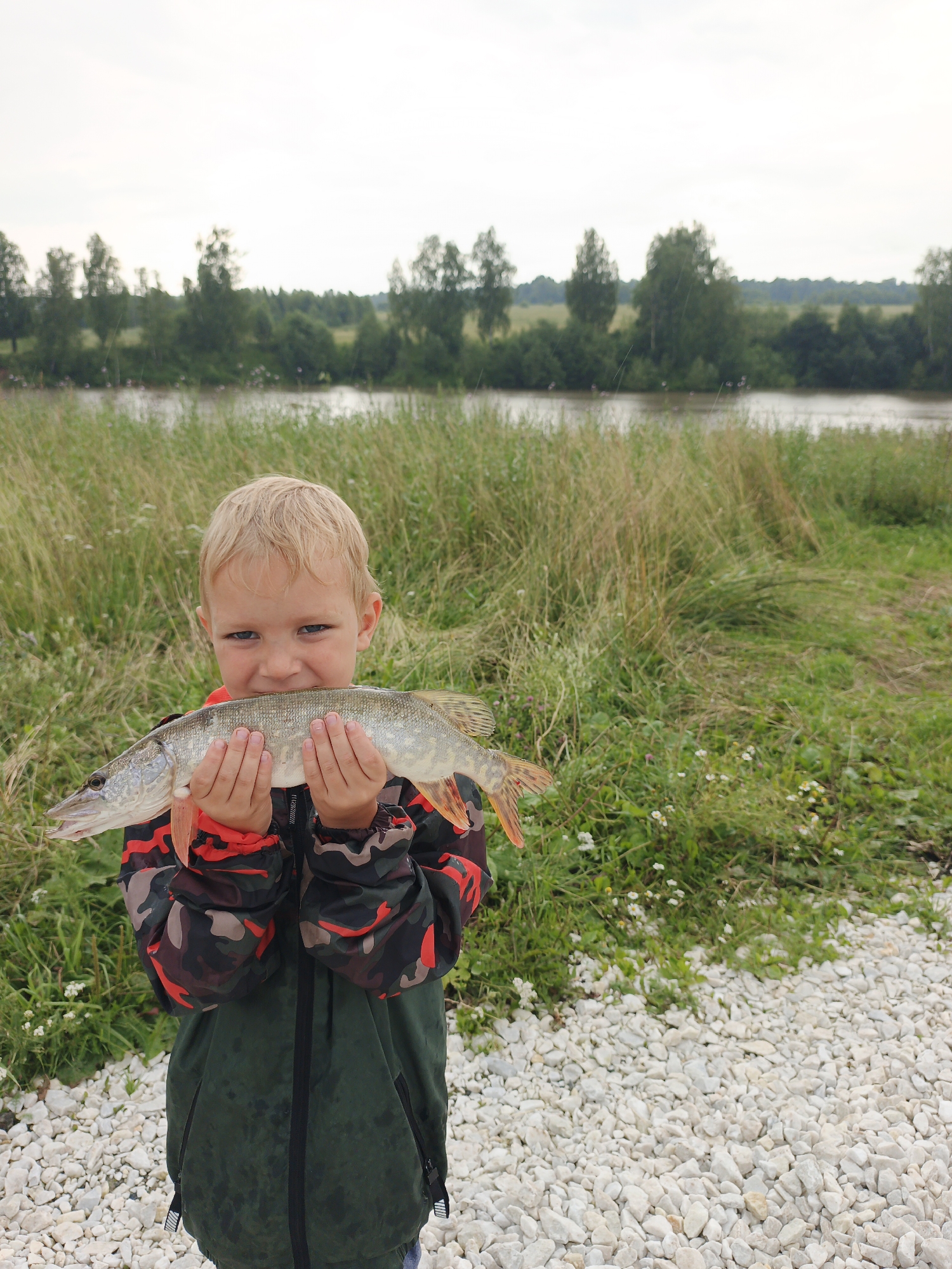 Pike caught on a cloudy morning at a Russian riverside