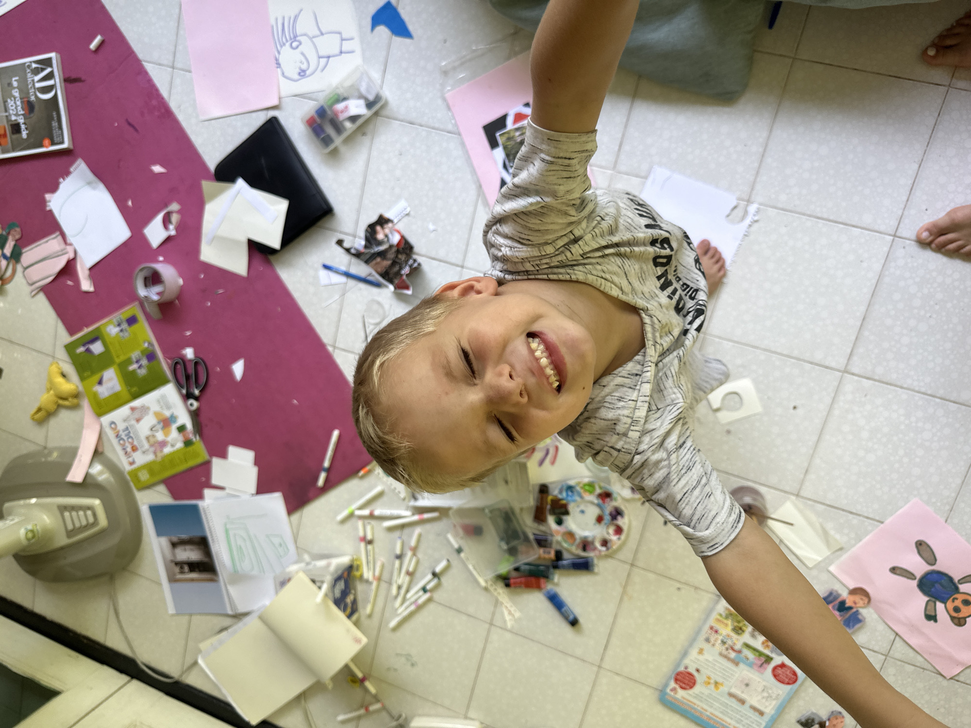 Child enjoys art time on floor in Thailand
