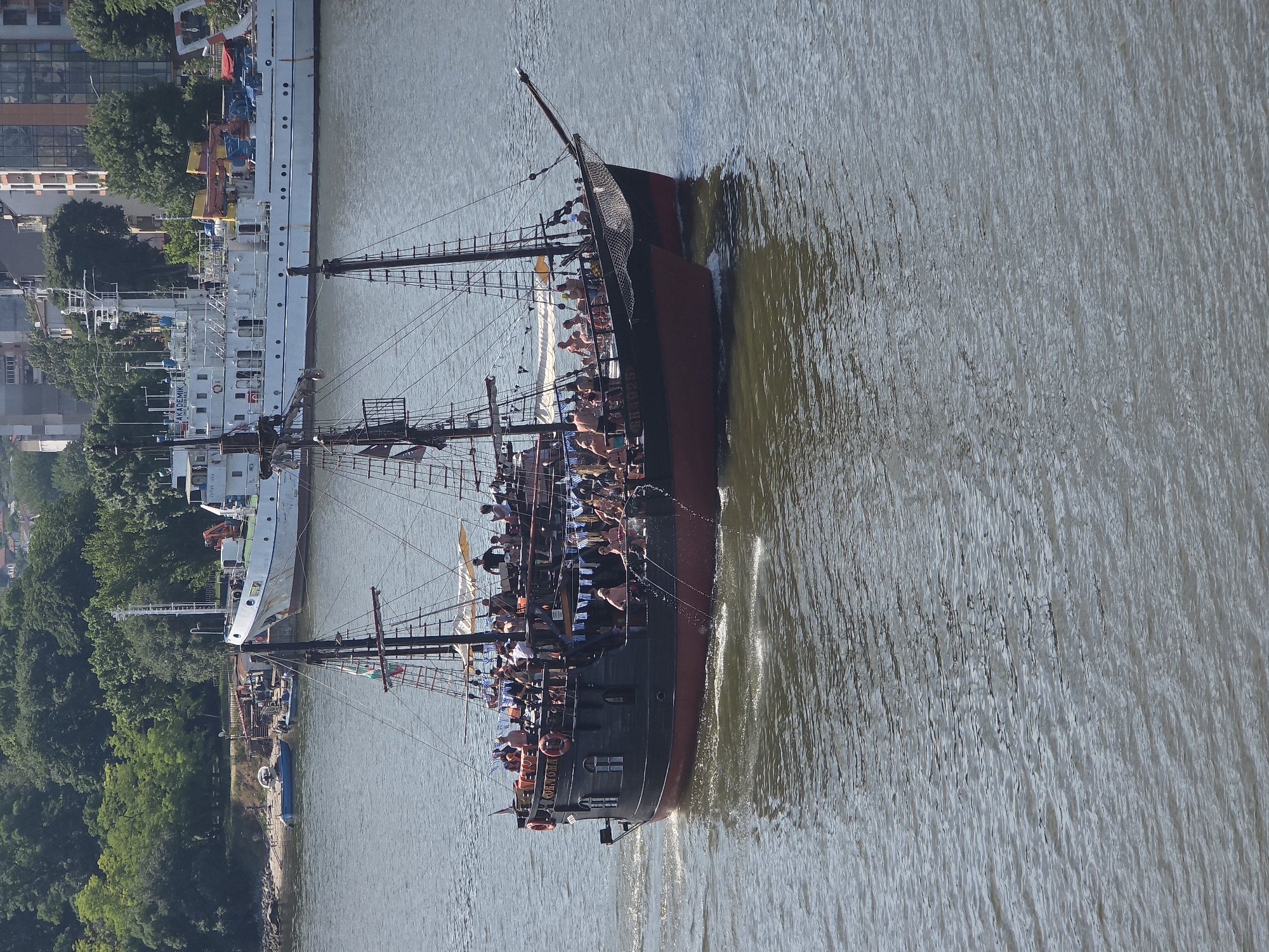 Pirate tourist boats cruise Varna Bay near working port