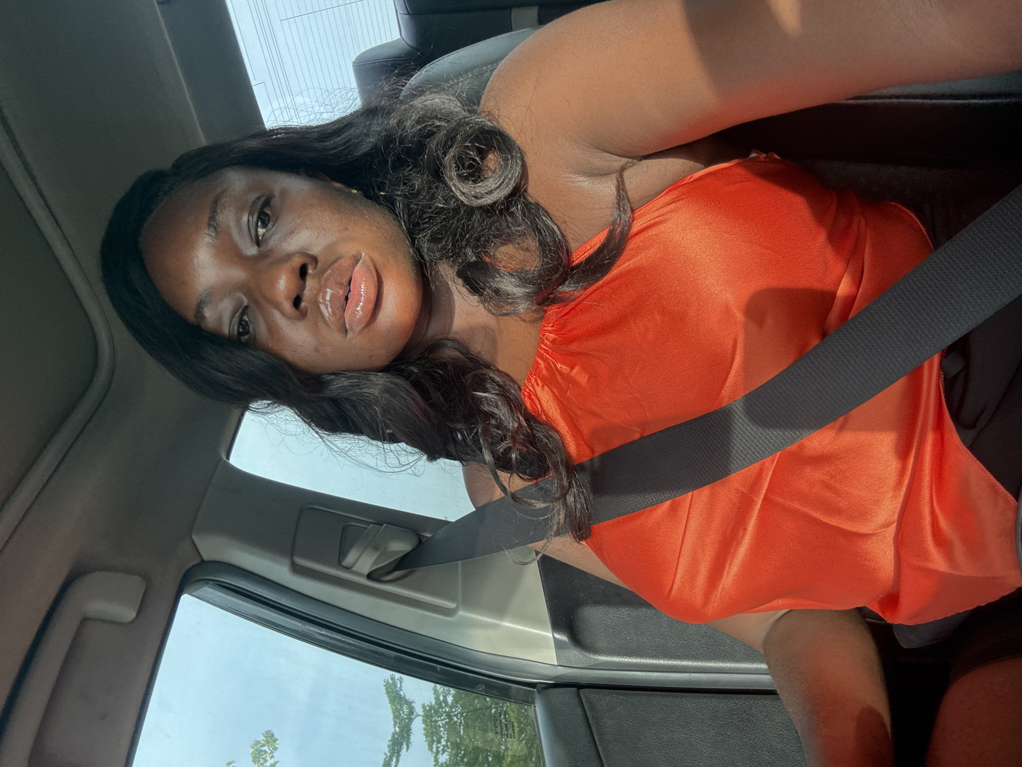 Woman in orange top observed in passenger seat, Kuchingoro