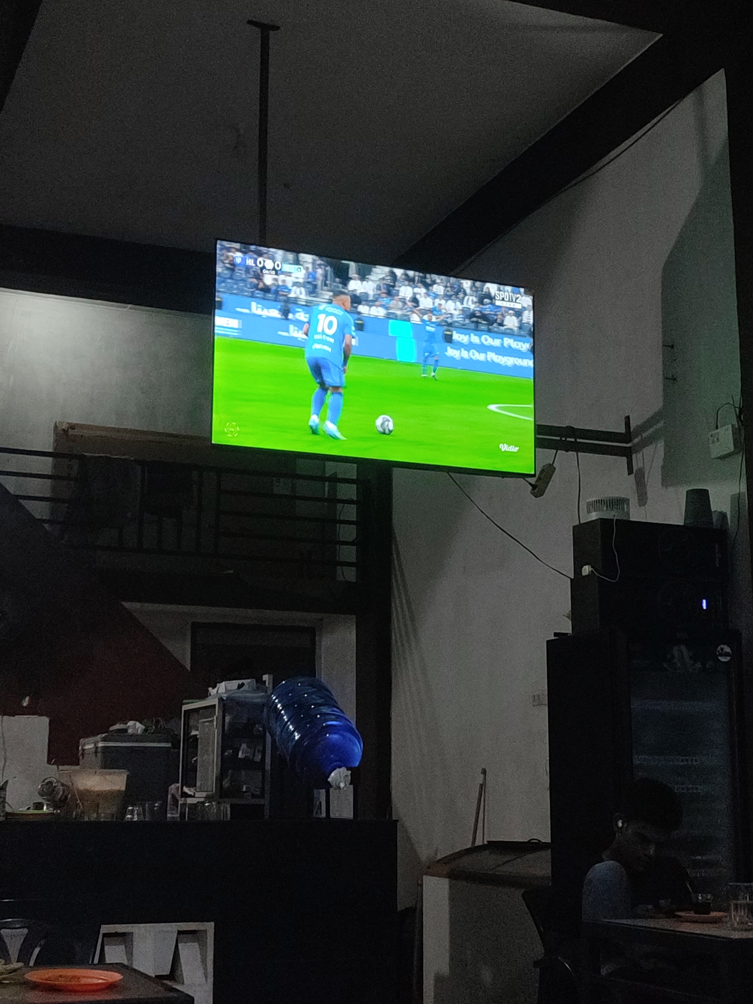 Soccer match broadcast viewed at Indonesian cafe