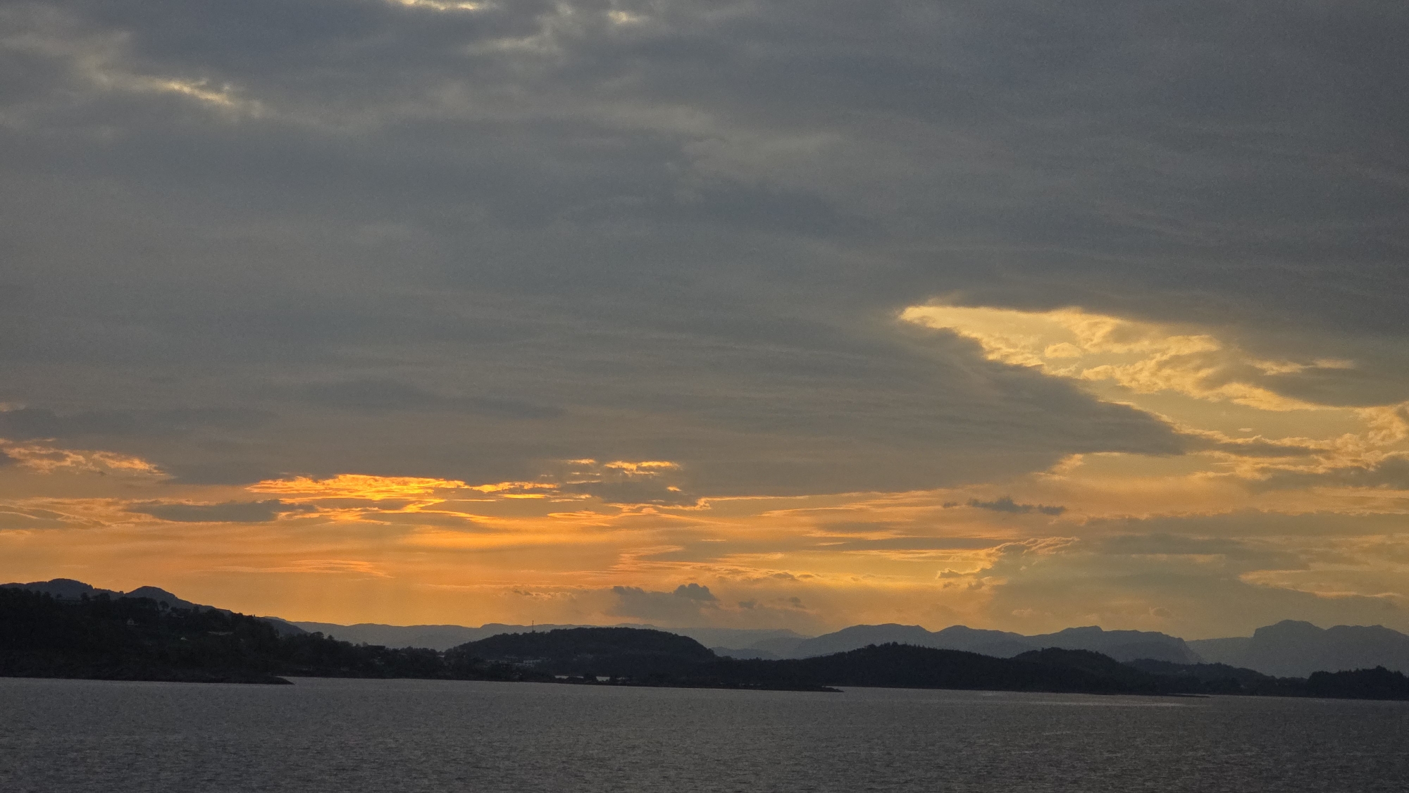 Dramatic sunset captured over Norwegian fjord waters in Randaberg