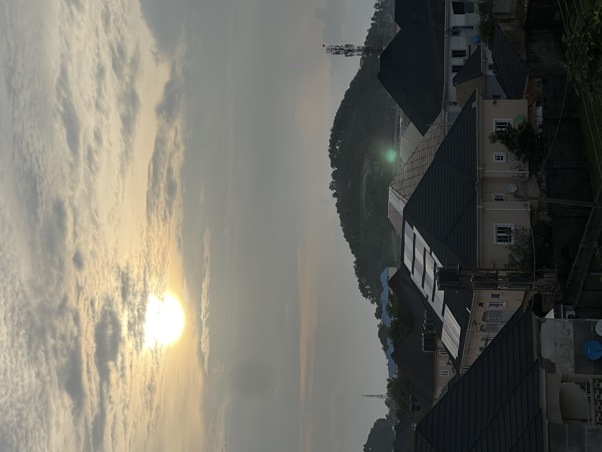 Abuja sunset watched from rooftops and window grills