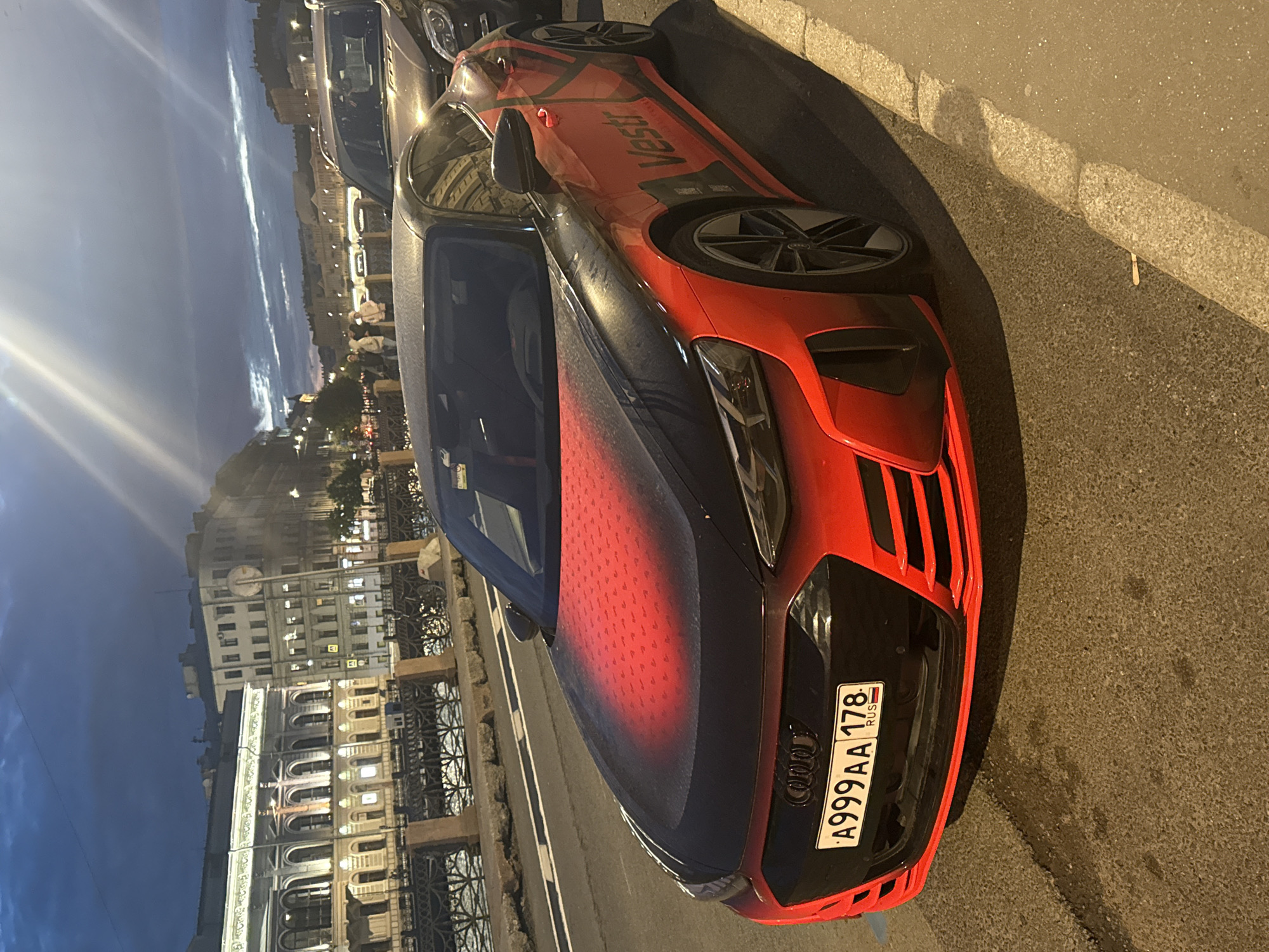 Late-night Saint Petersburg: cars, a night rider, and classic facades
