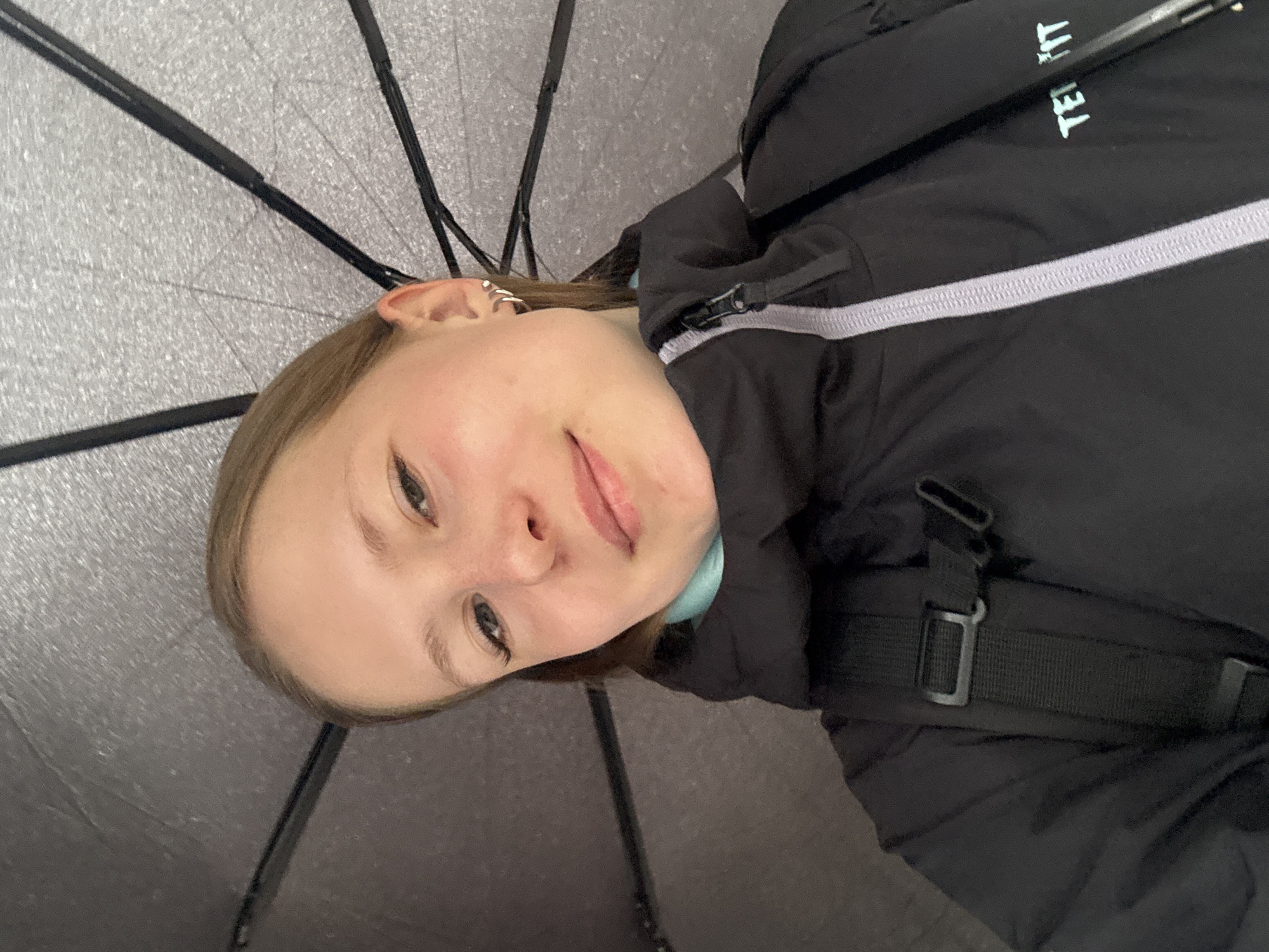 Woman photographed under umbrella during cloudy night in Chaikovsky