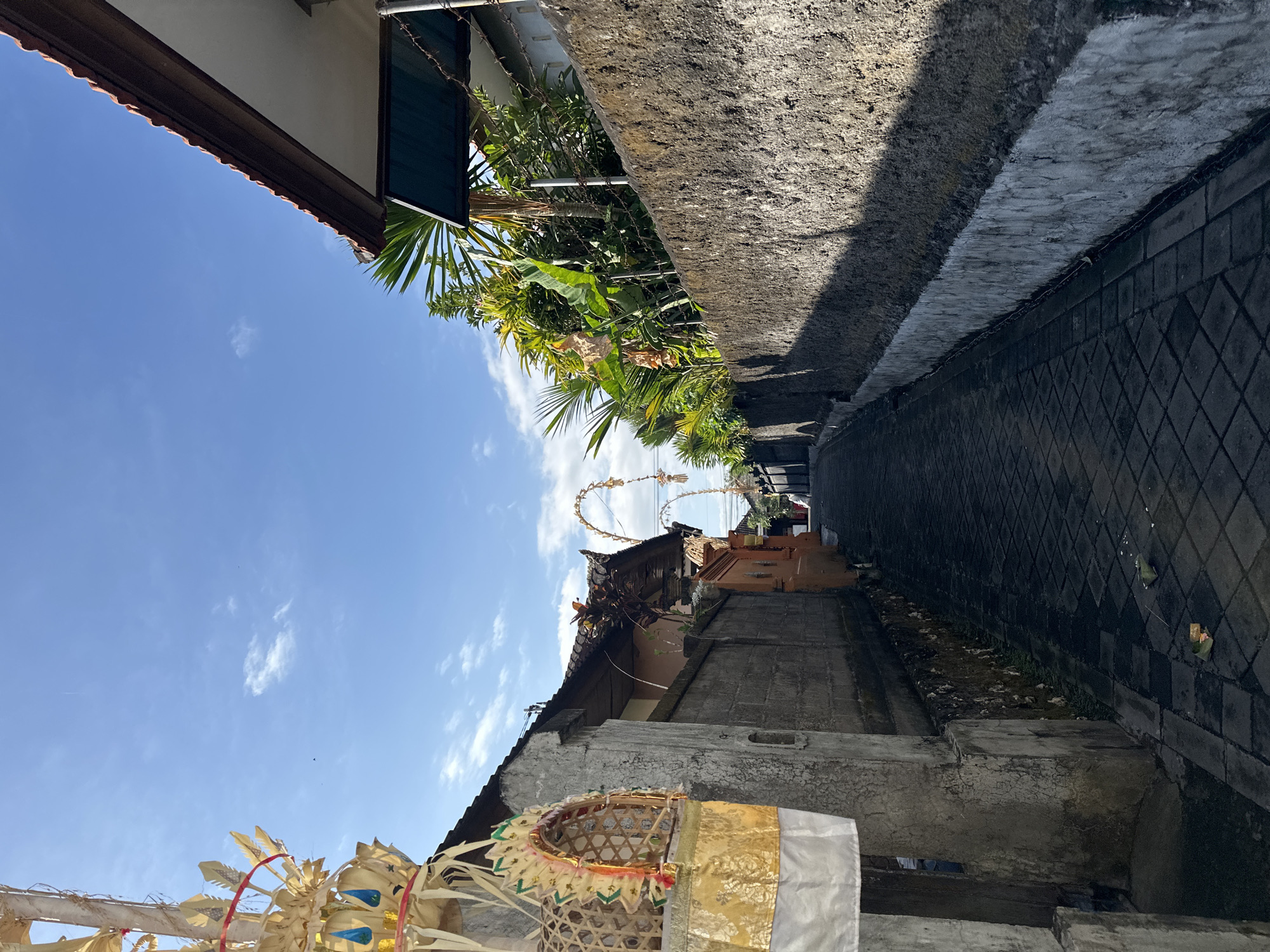 Wandering a quiet Balinese alleyway neighborhood, store stop included