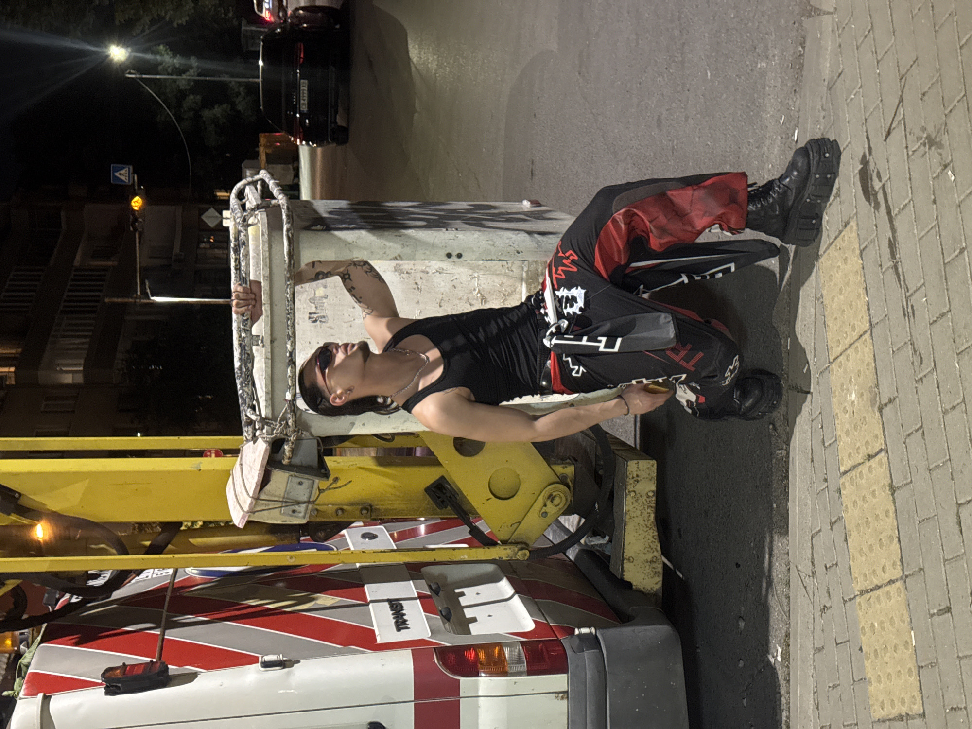 Person spotted leaning against dumpster on Sofia street at night