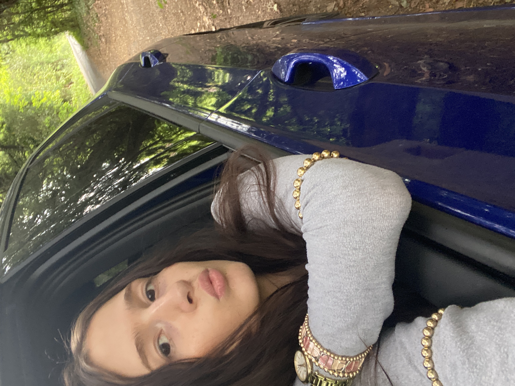 Young couple photographed with blue car in Upper Basildon