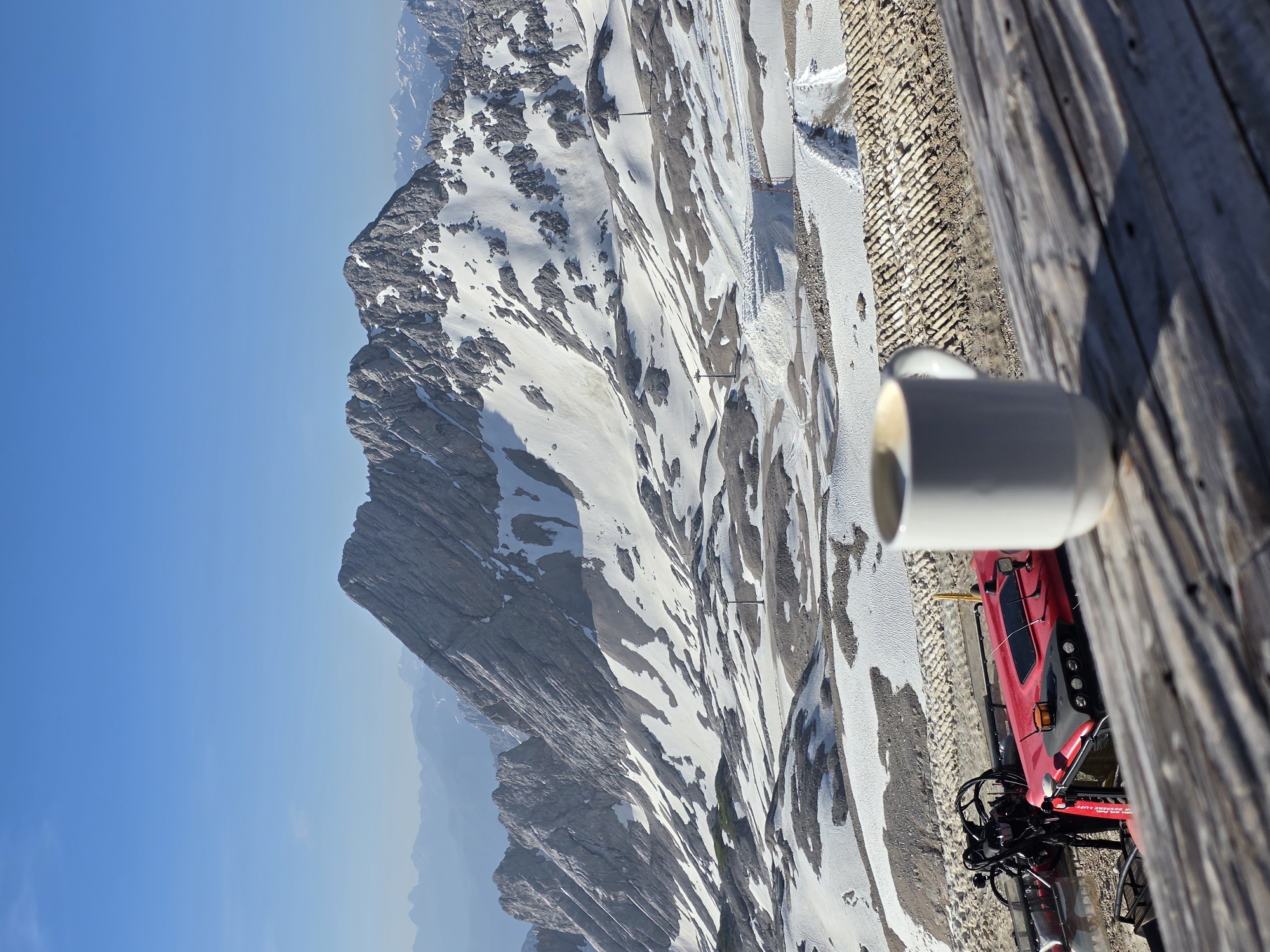 Coffee and snow groomers on the Zugspitze on a clear June morning