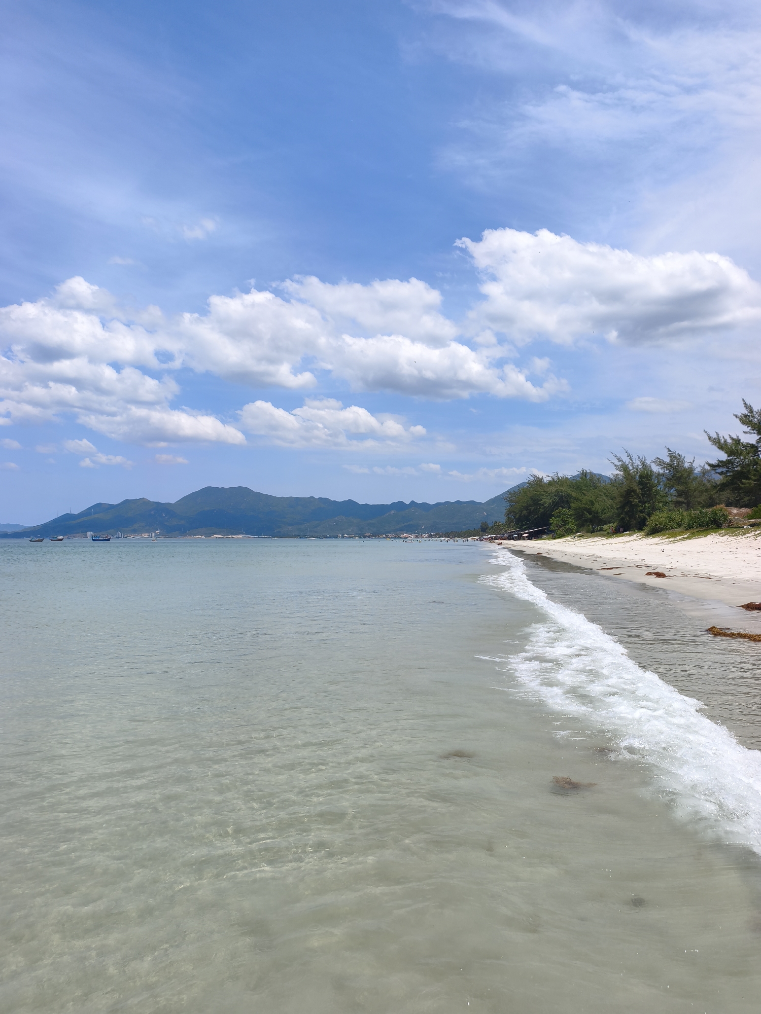 Clear shallow water and mountain views at a Vietnamese beach