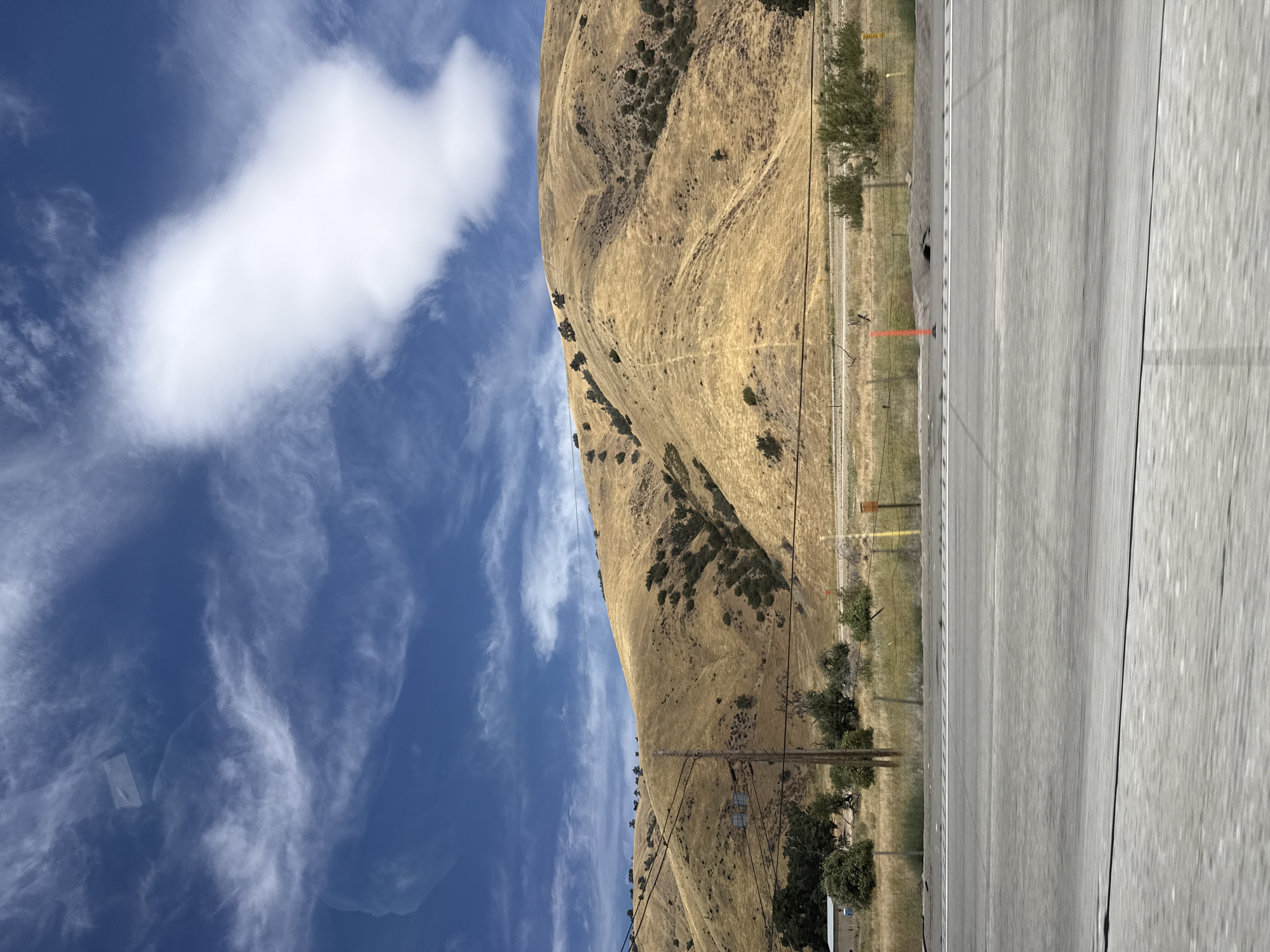 Highway drive through dry golden hills near Lebec, California