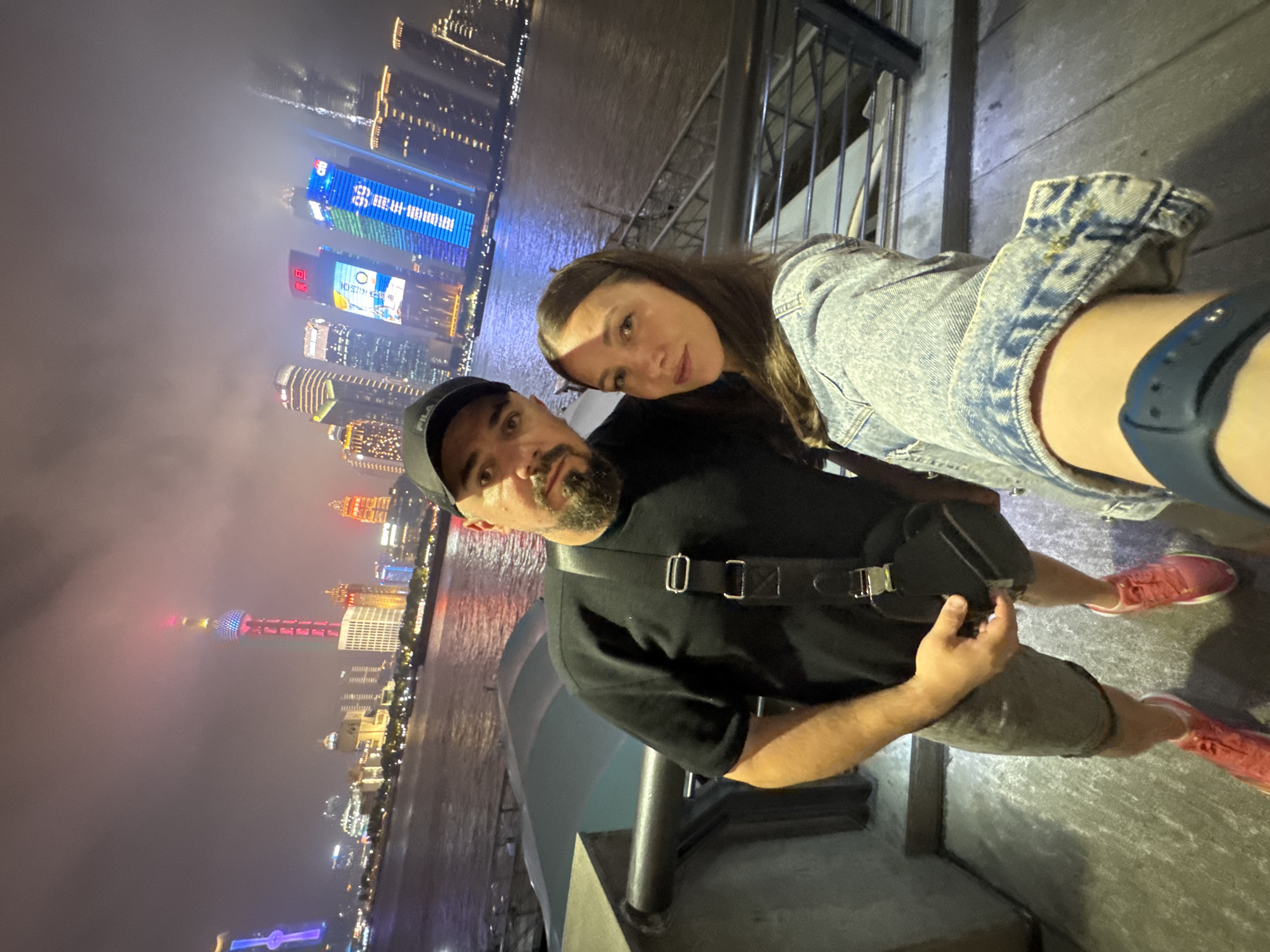 Shanghai skyline captured by tourists during foggy evening hours