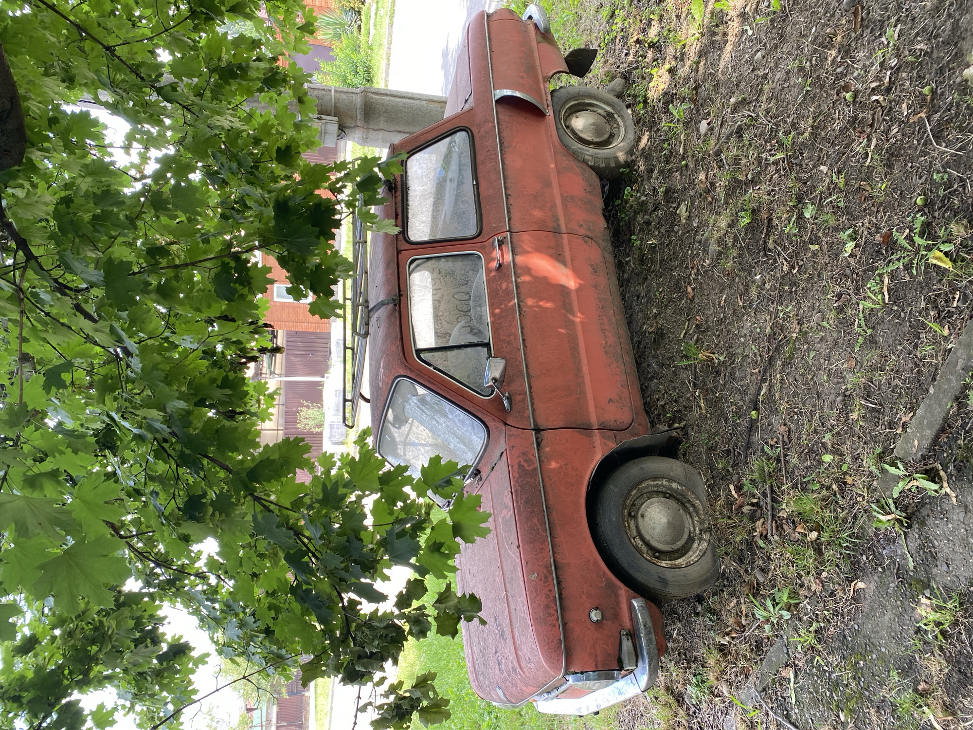 Parked cars along Maykop streets, one seriously weathered