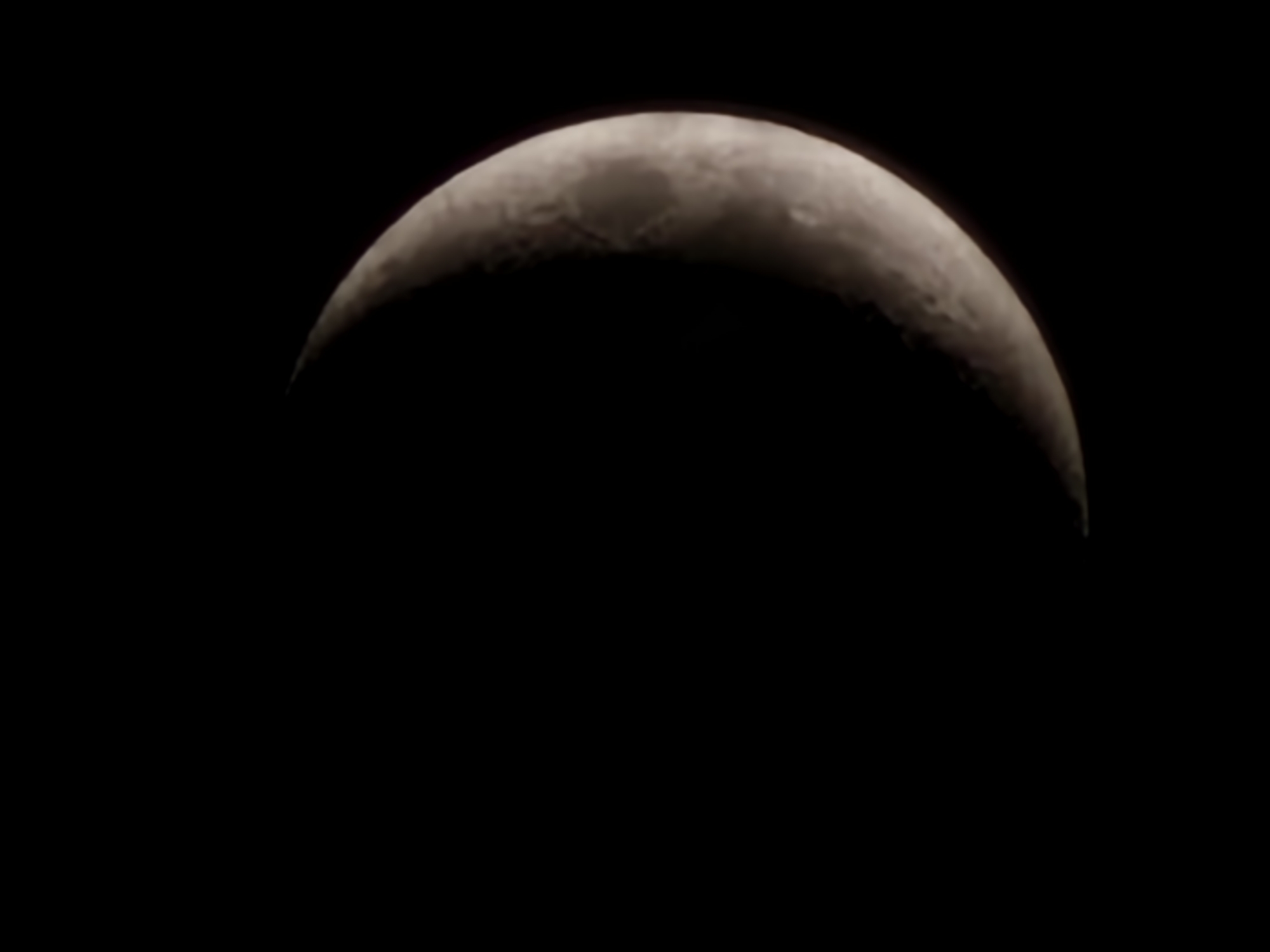 Crescent moon rising over Esch-sur-Alzette at dusk