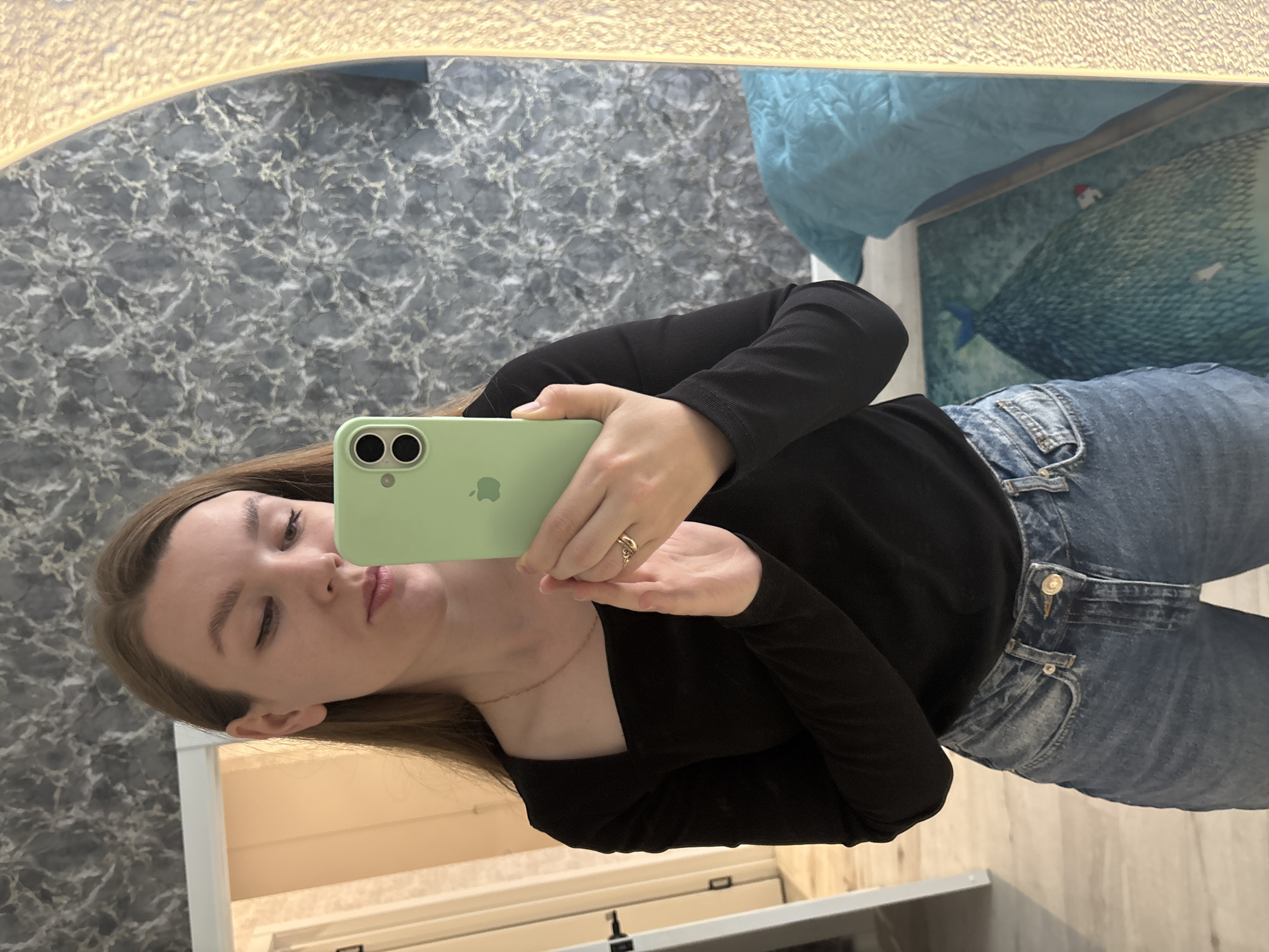 Woman takes mirror selfie with cats watching in Izhevsk
