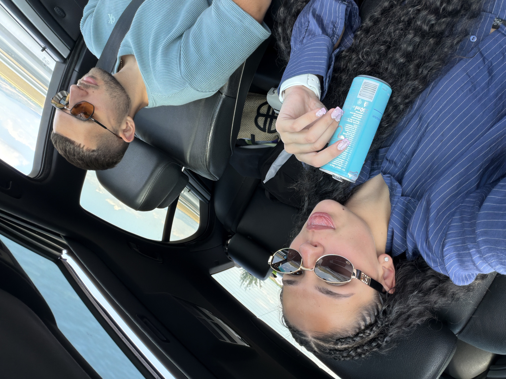 Inside a car in rural Bulgaria, blue can in hand