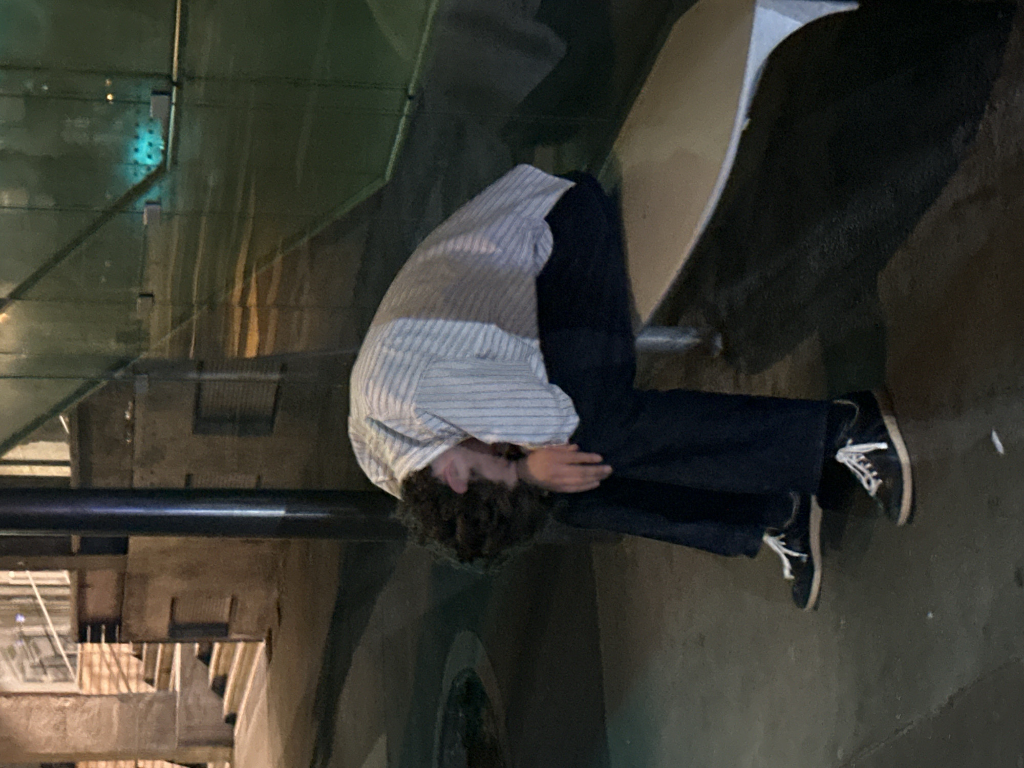 Quiet moment on a Paris bench, head down, facing away