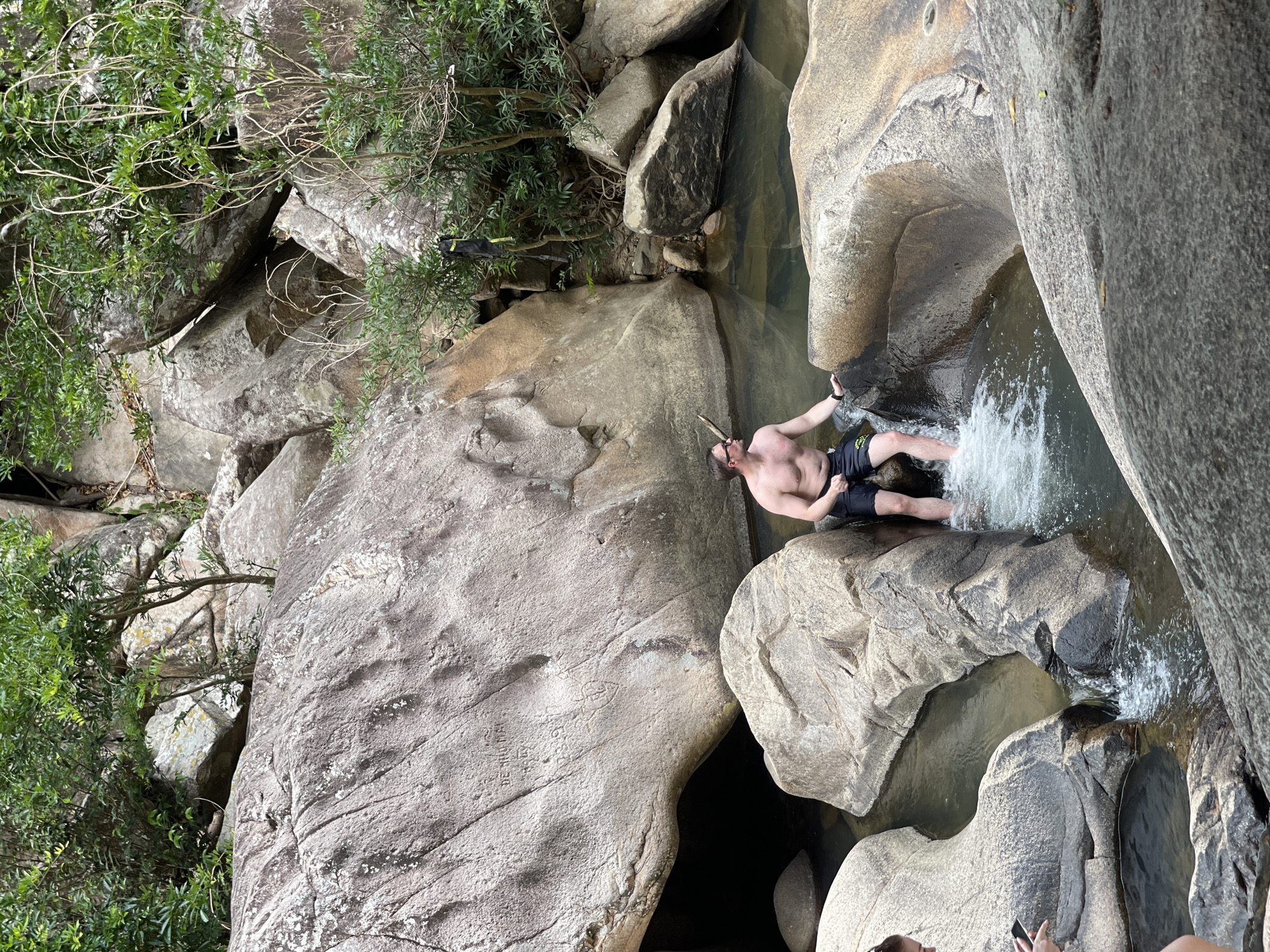 Man wades among boulders at Vietnamese rocky coast