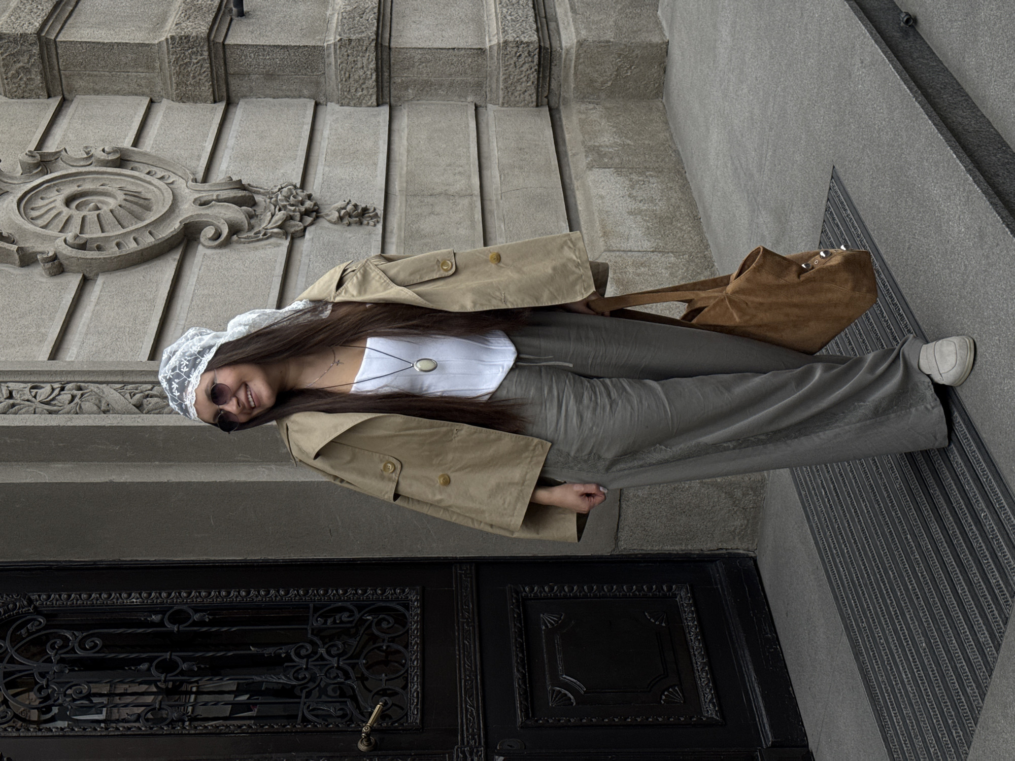 Woman poses for photos at ornate Belgrade building