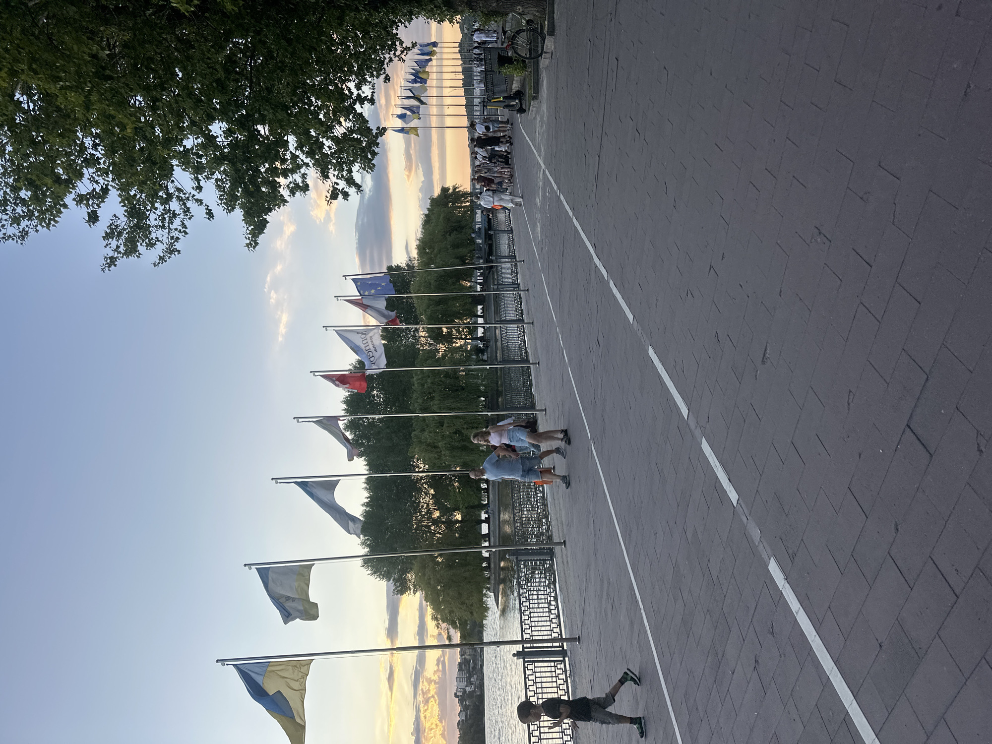 Sunset hour at Ternopil Lake's busy waterfront promenade.