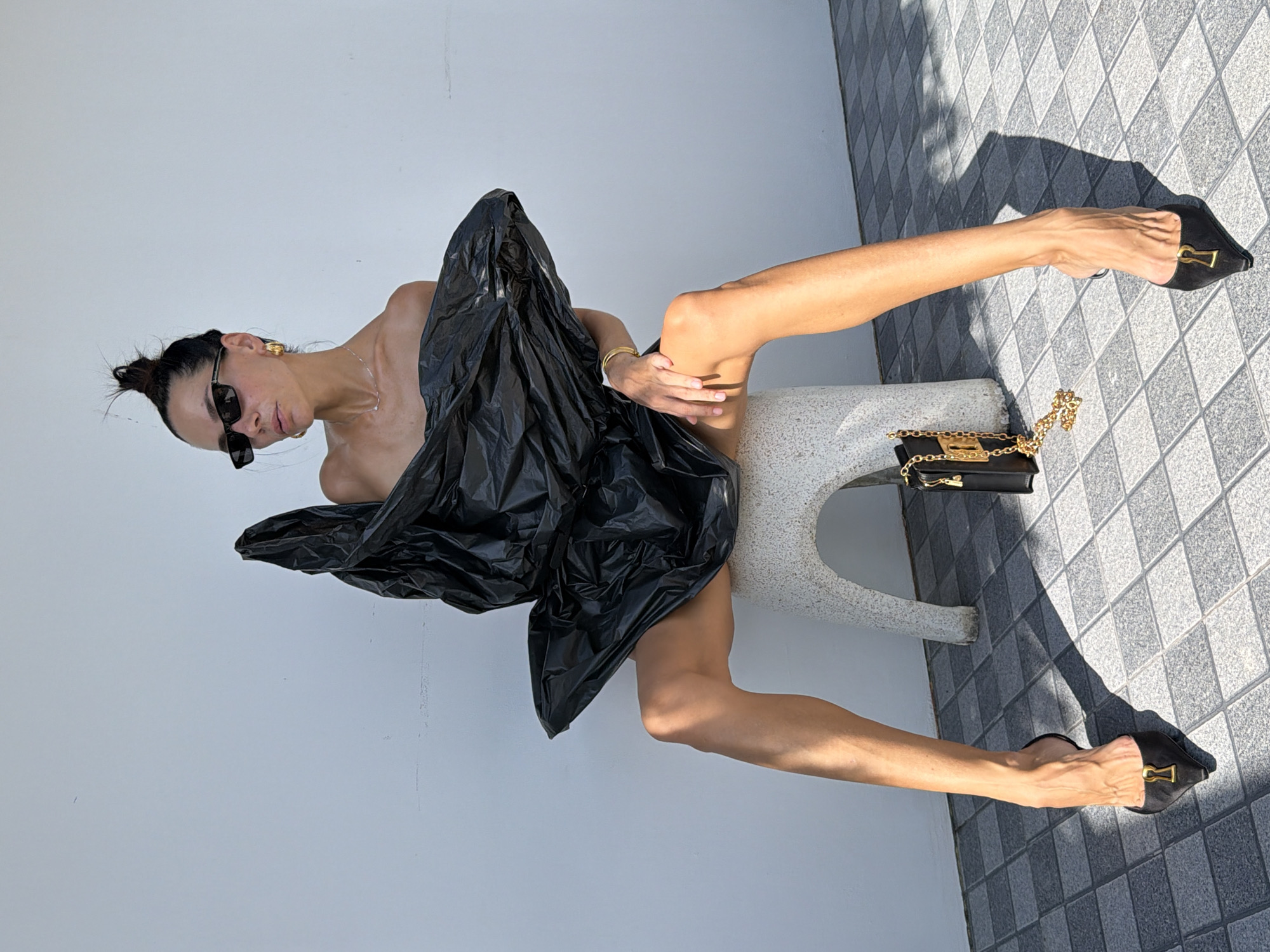 Black statement dress shoot against a white wall in Ko Samui