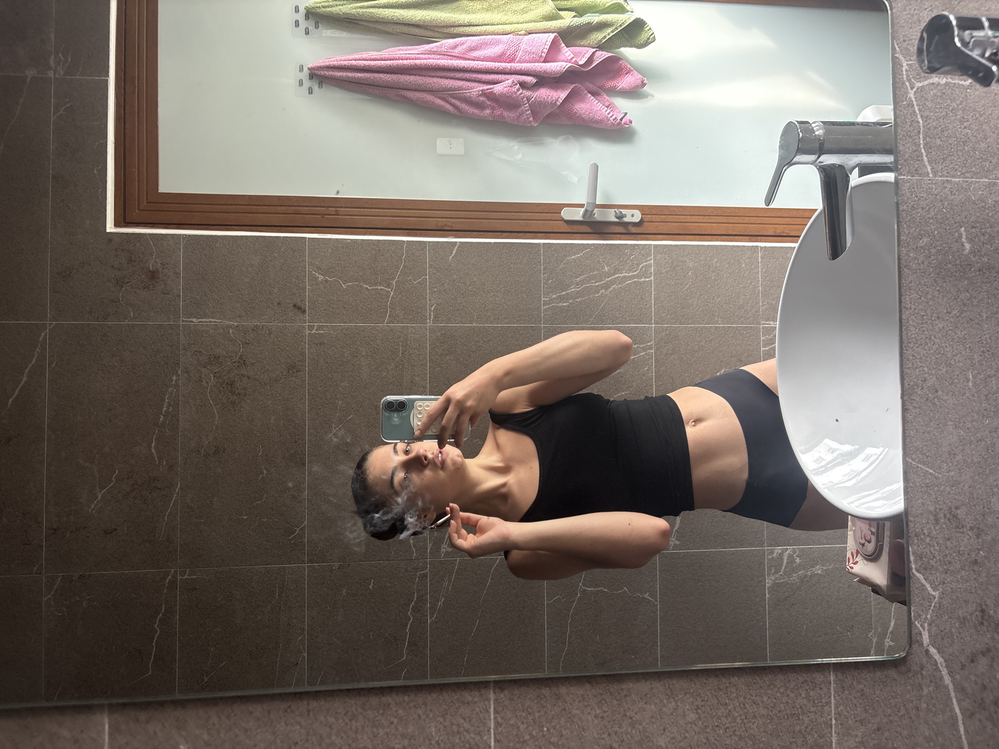 Woman takes mirror selfie in Đà Nẵng bathroom