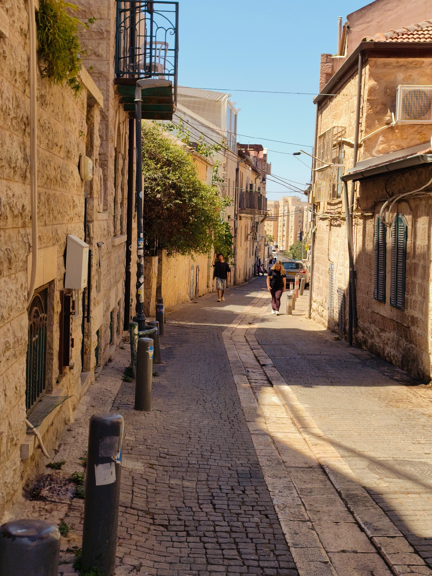 Morning light on a quiet cobblestone alley in Jerusalem