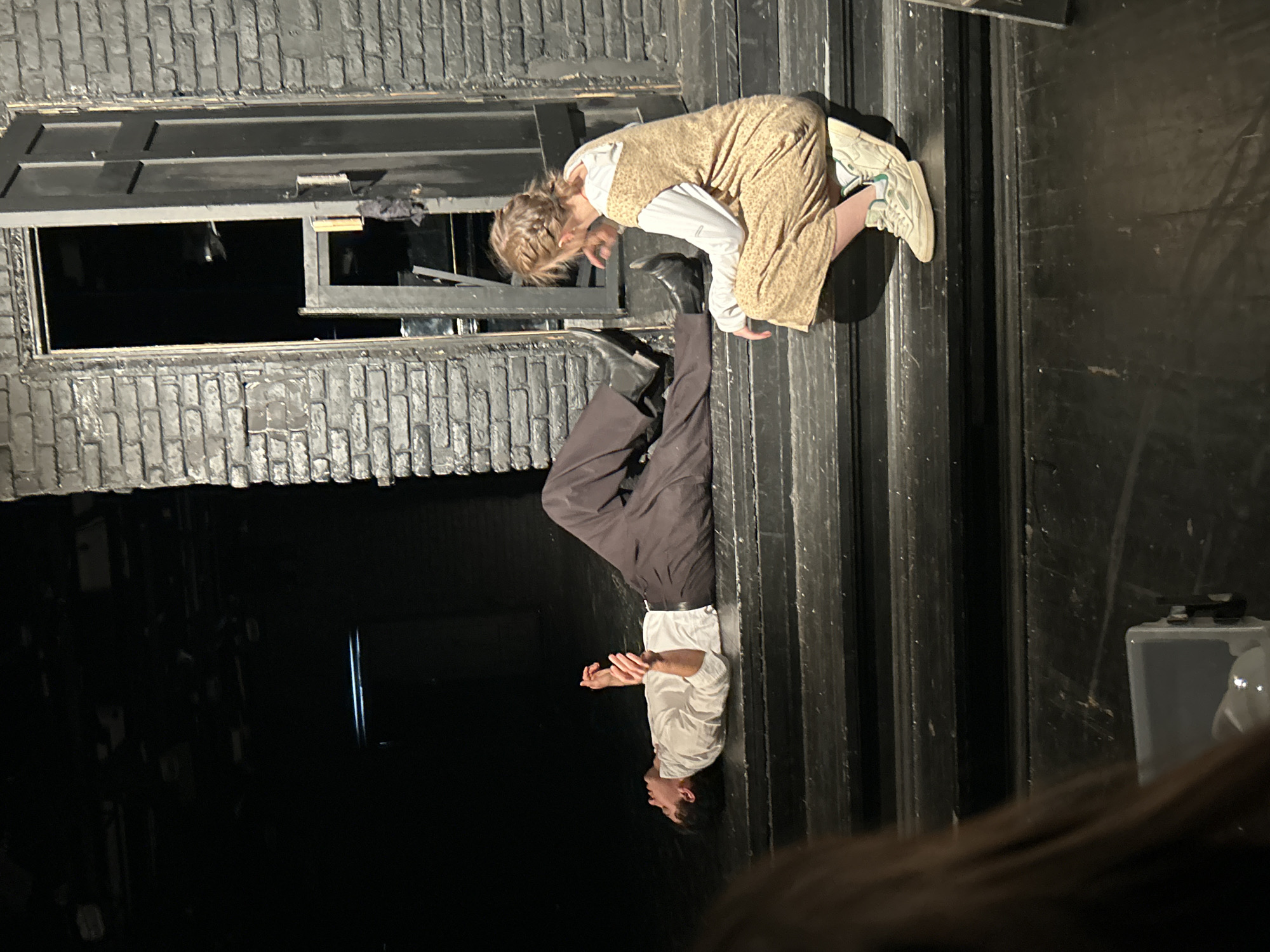 Theatrical performance captured by witnesses on stage with period costumes