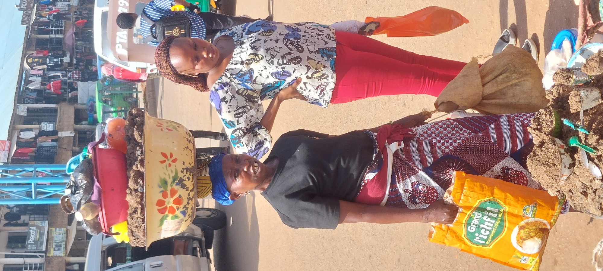 Street market activity: vendors and foot traffic in a dusty urban setting