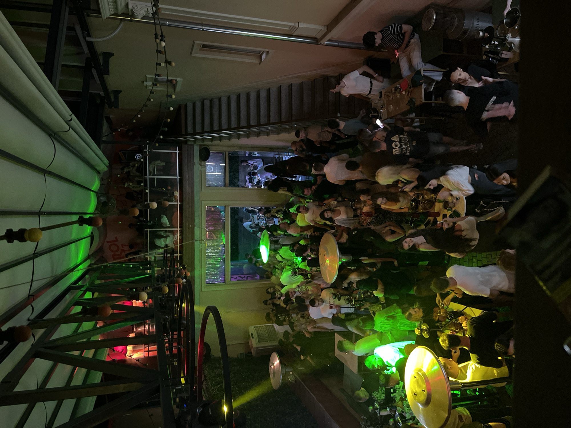 Crowded urban bar hosts lively evening social gathering