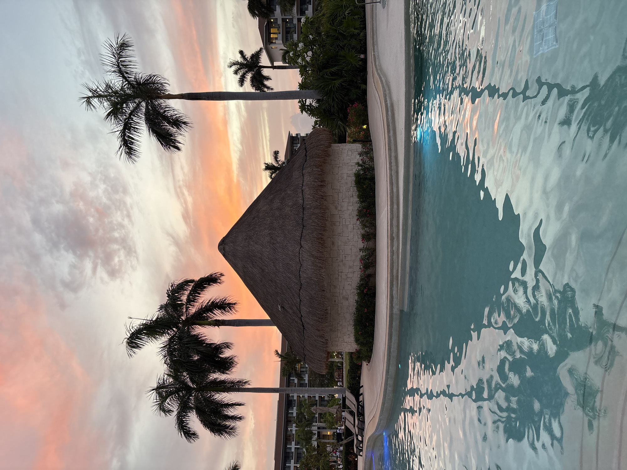 Sunset poolside at a Punta Sam resort, Delphinus Maroma