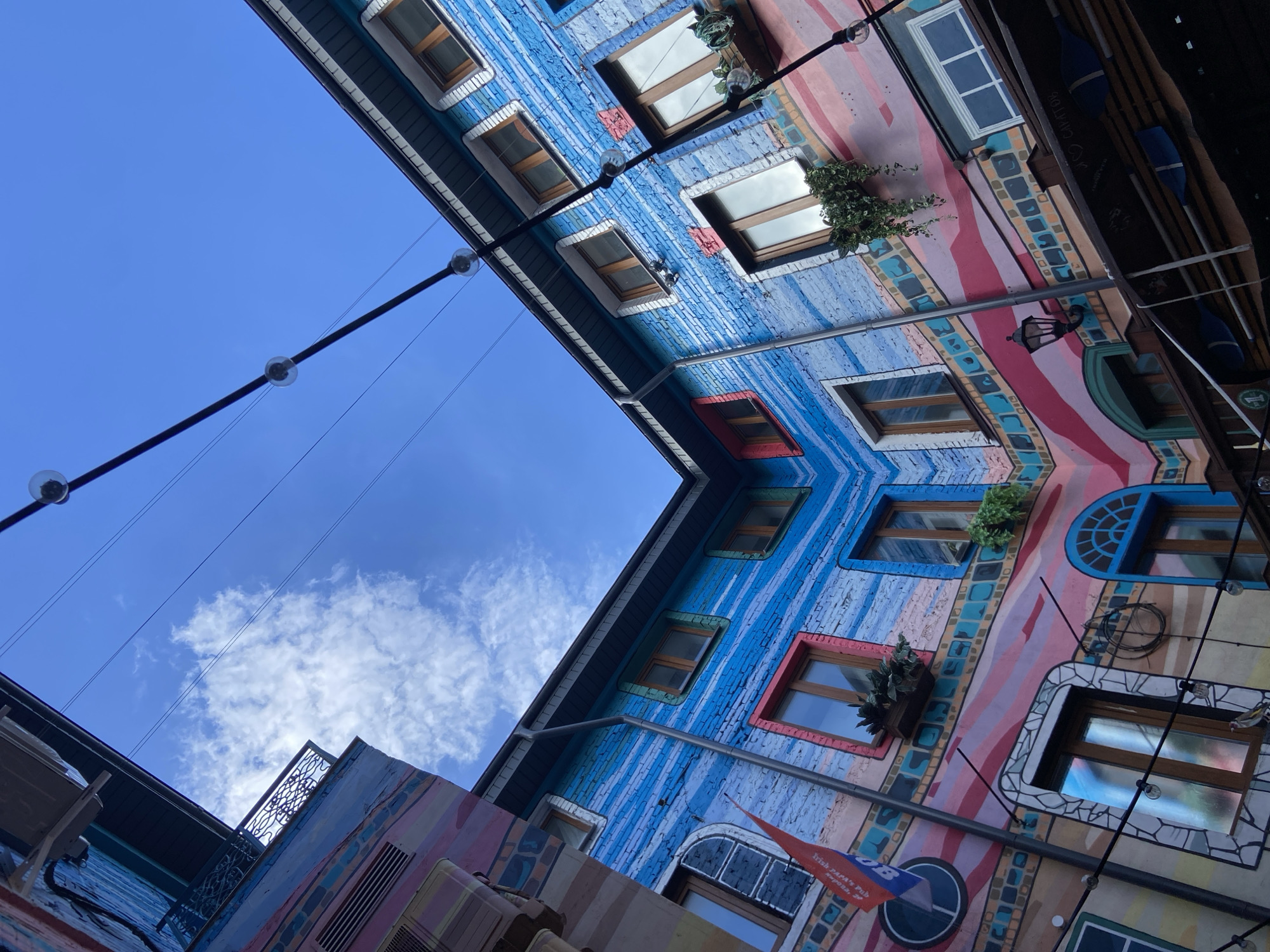 Red car towed on Saratov street amid colorful architecture