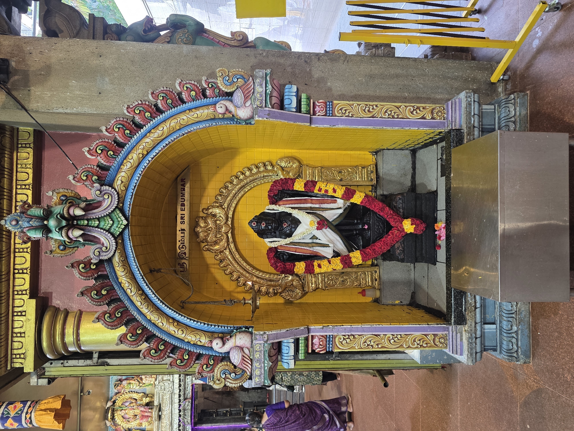 Devotees gather at a decorated Hindu temple shrine in Singapore
