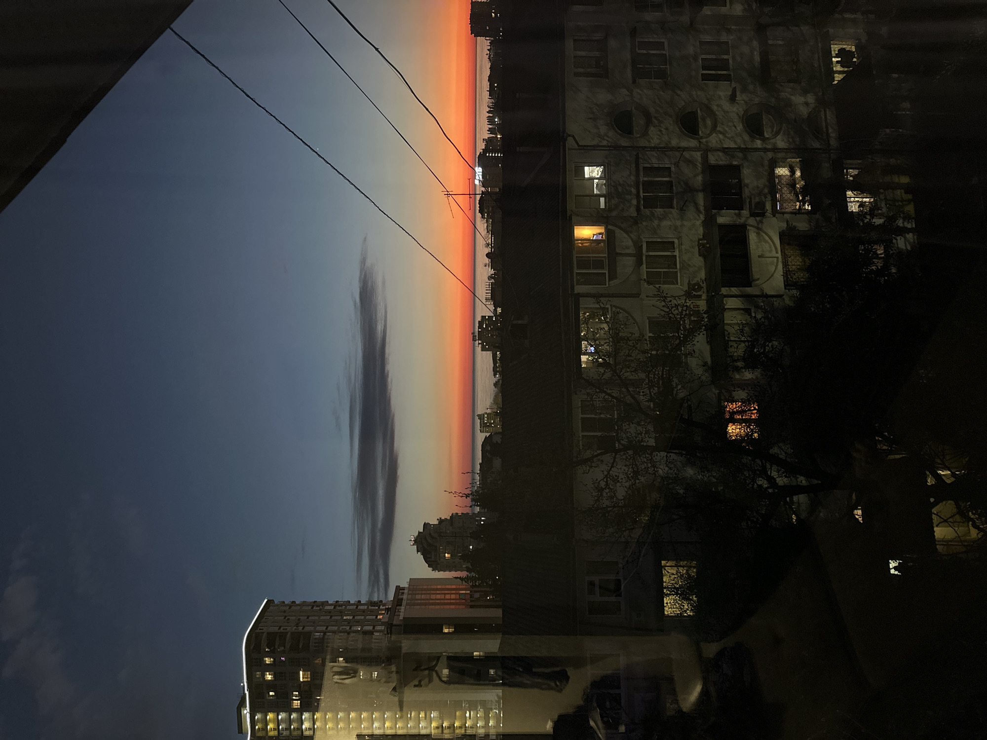 Evening sunset illuminates Sochi cityscape with orange sky