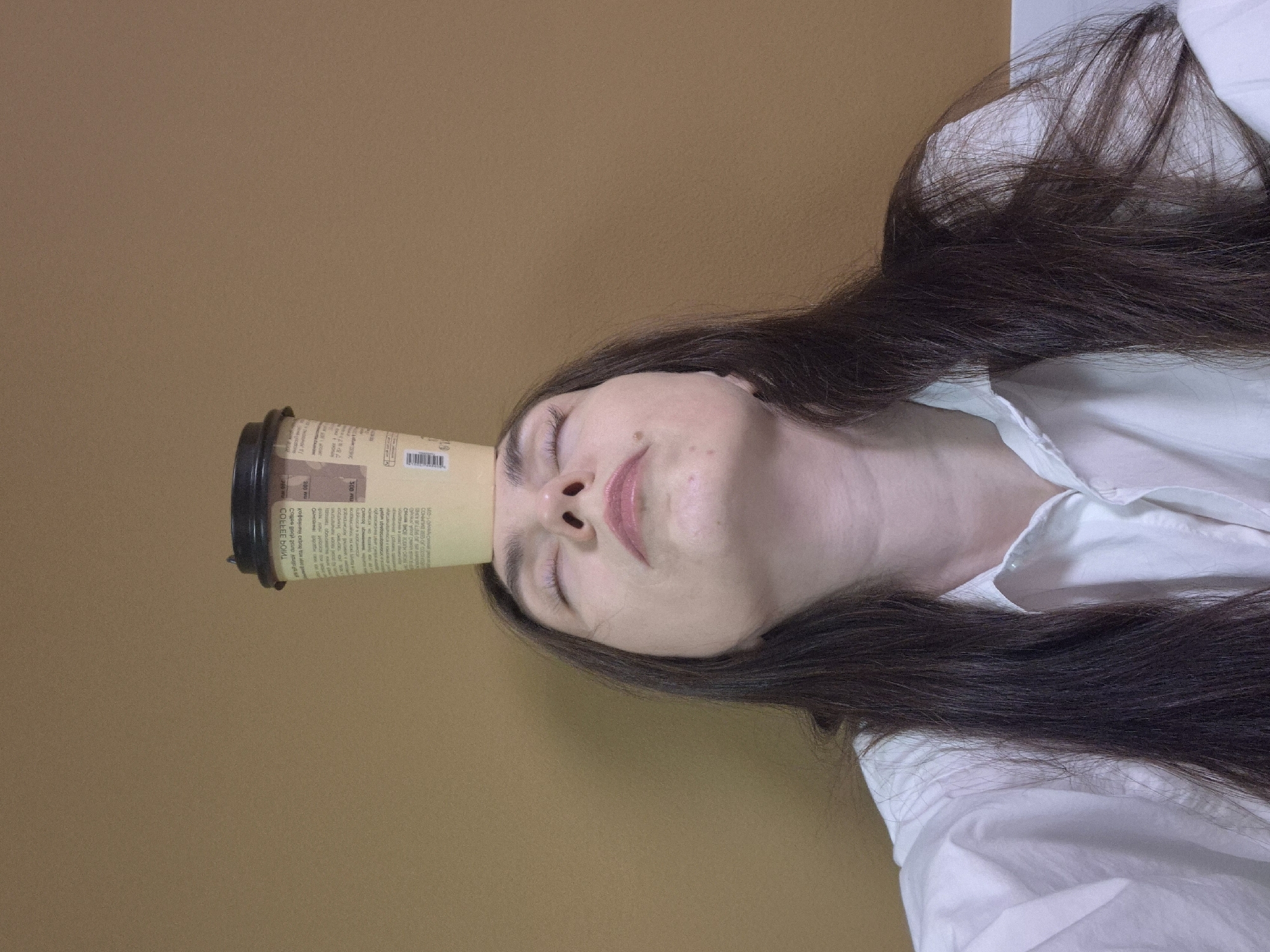 Woman plays with coffee cup in early morning moment