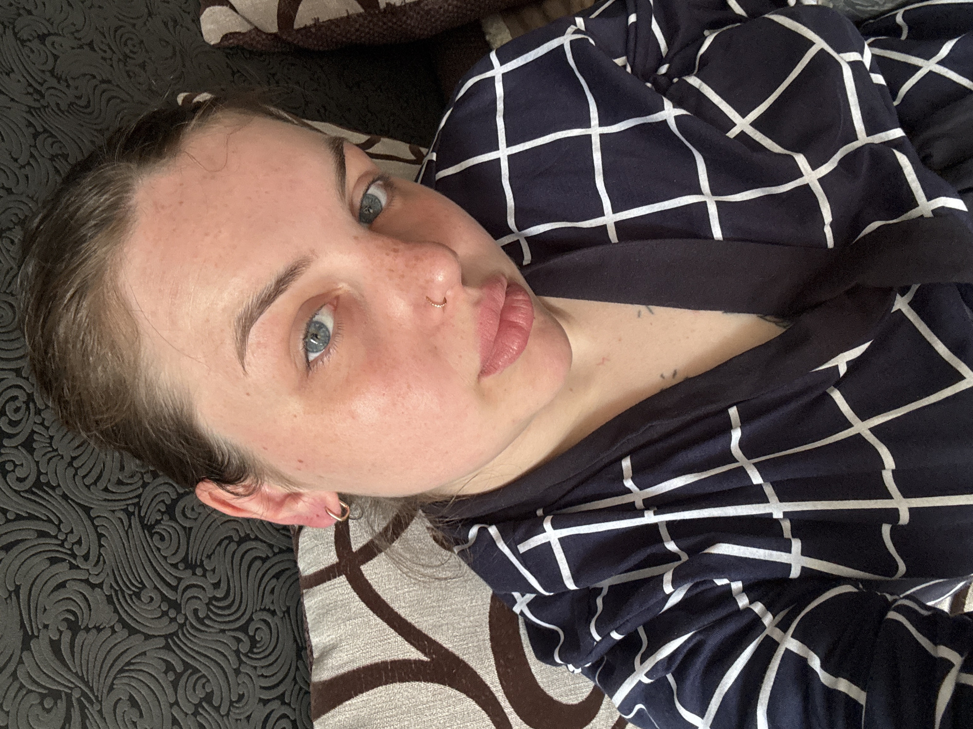 Woman makes playful expressions while resting indoors in Ukraine