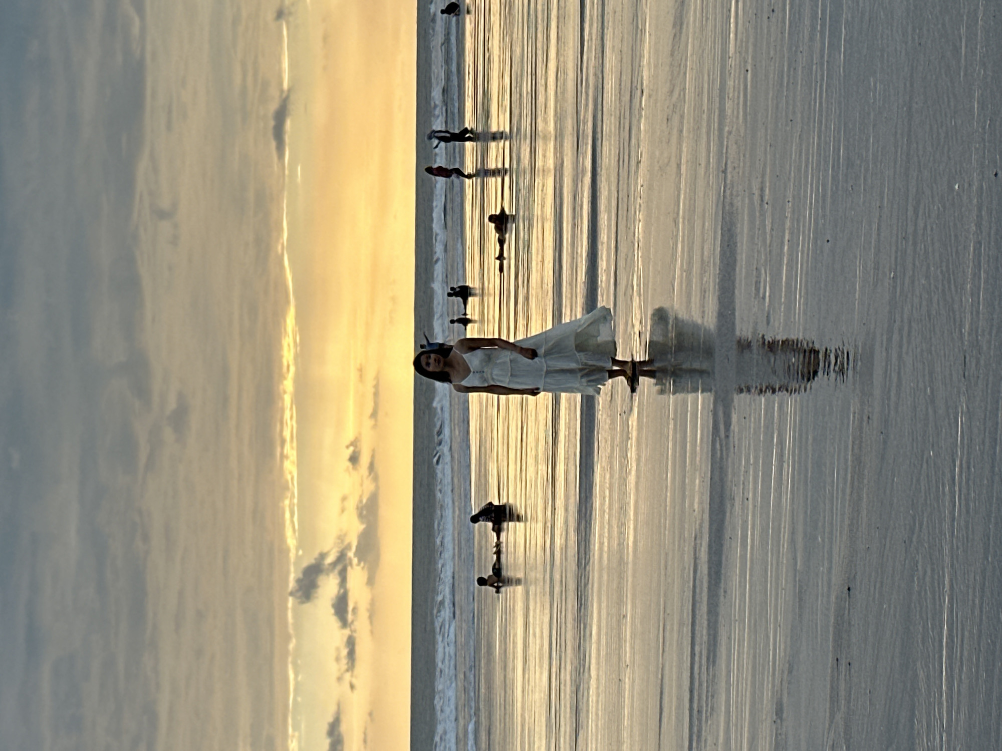 Busy North Kuta beach sunset with families and a photo shoot