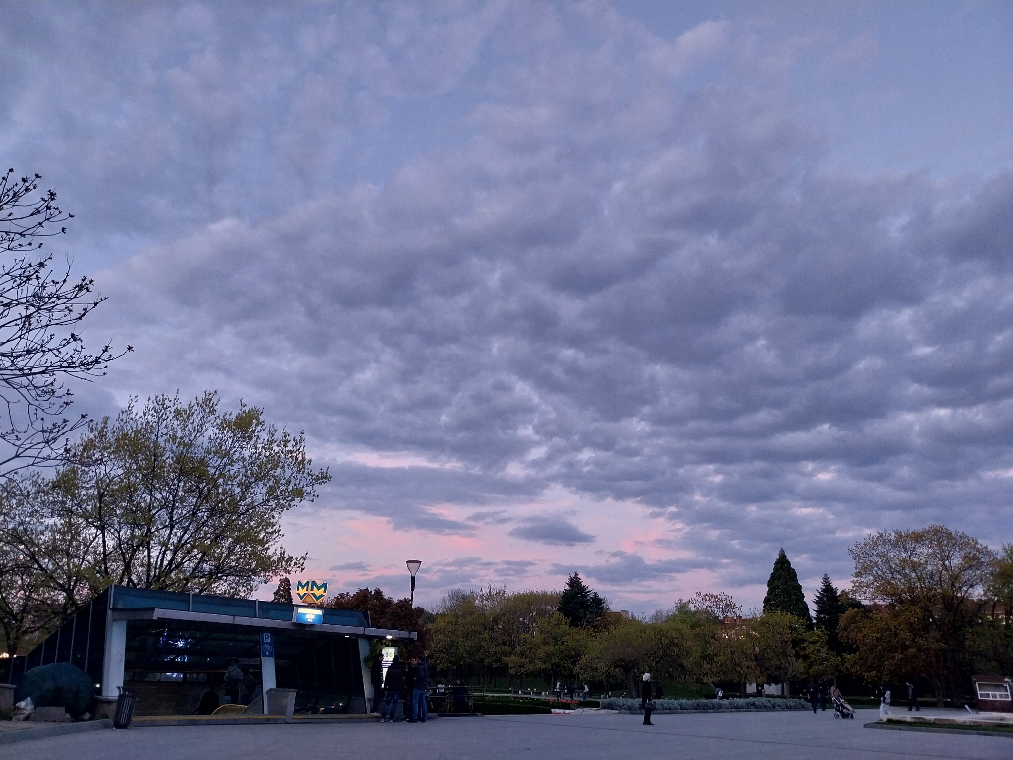 Dusk scene captured near metro system under heavy clouds