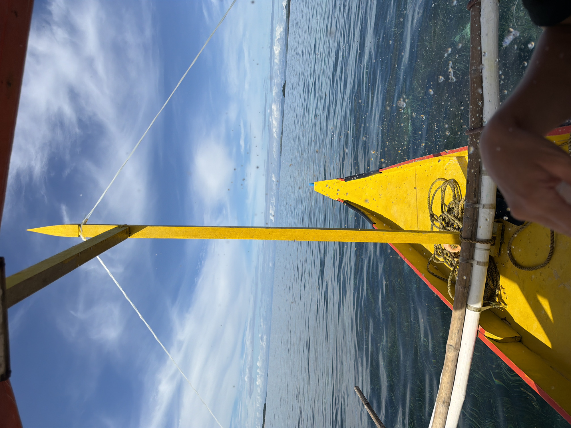Woman applies sunscreen during outrigger boat ride in Philippines