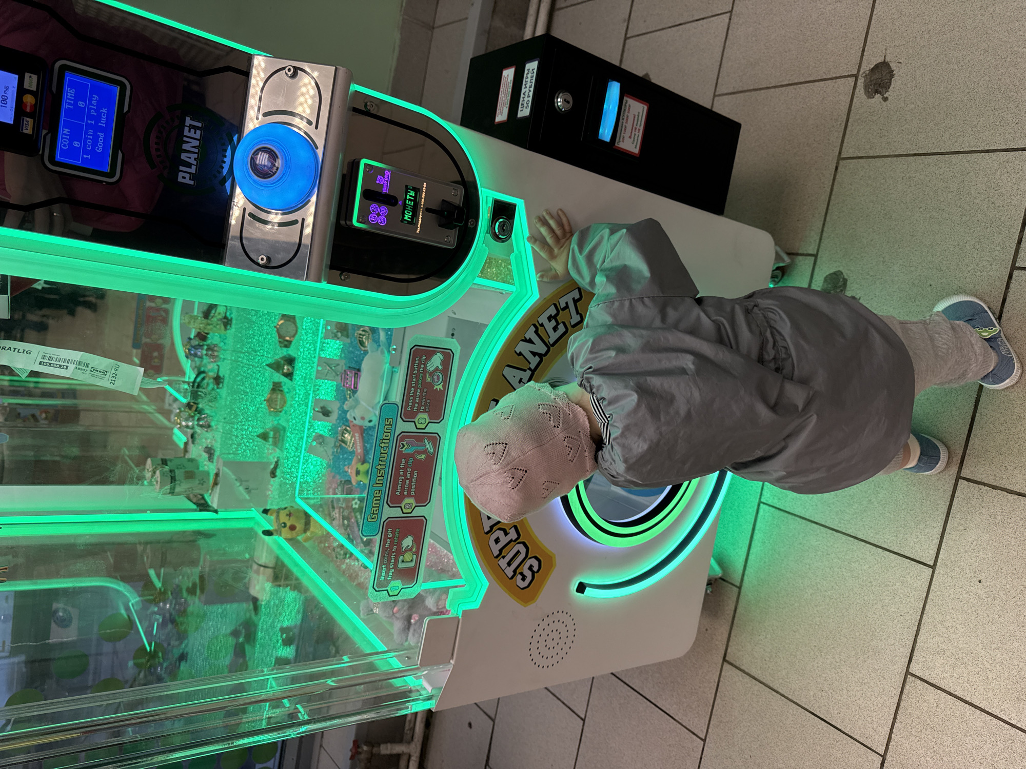 Child plays arcade games amid spring blossoms in Moscow