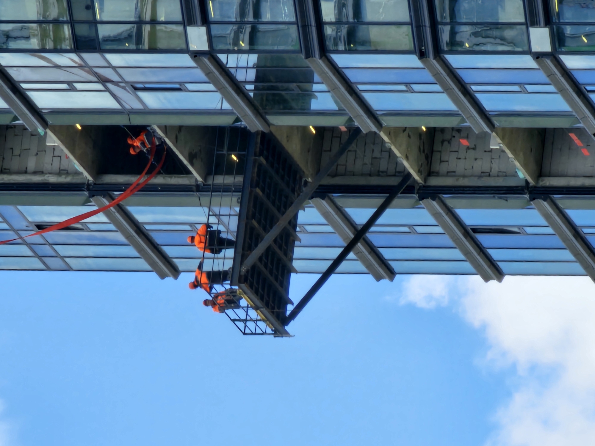 Moscow high-rise construction site, workers on exterior facades