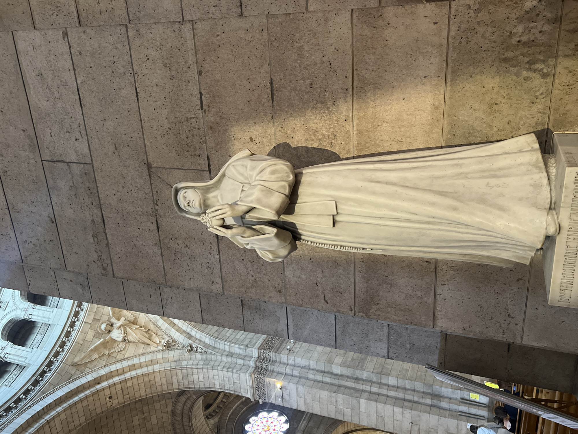Visitor documents Sacré-Cœur Basilica interior architecture and religious artifacts