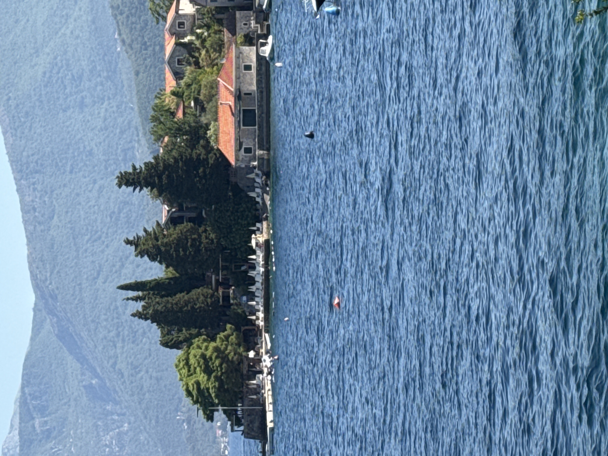 Morning at a Mediterranean waterfront with boats and selfies