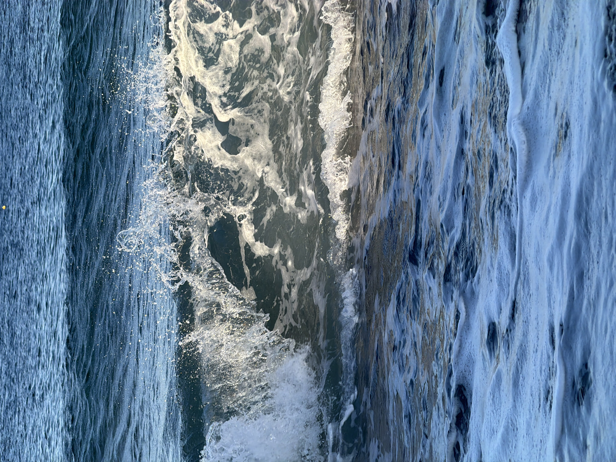 Aegean cliffs, waves, and a summit perch in Santorini