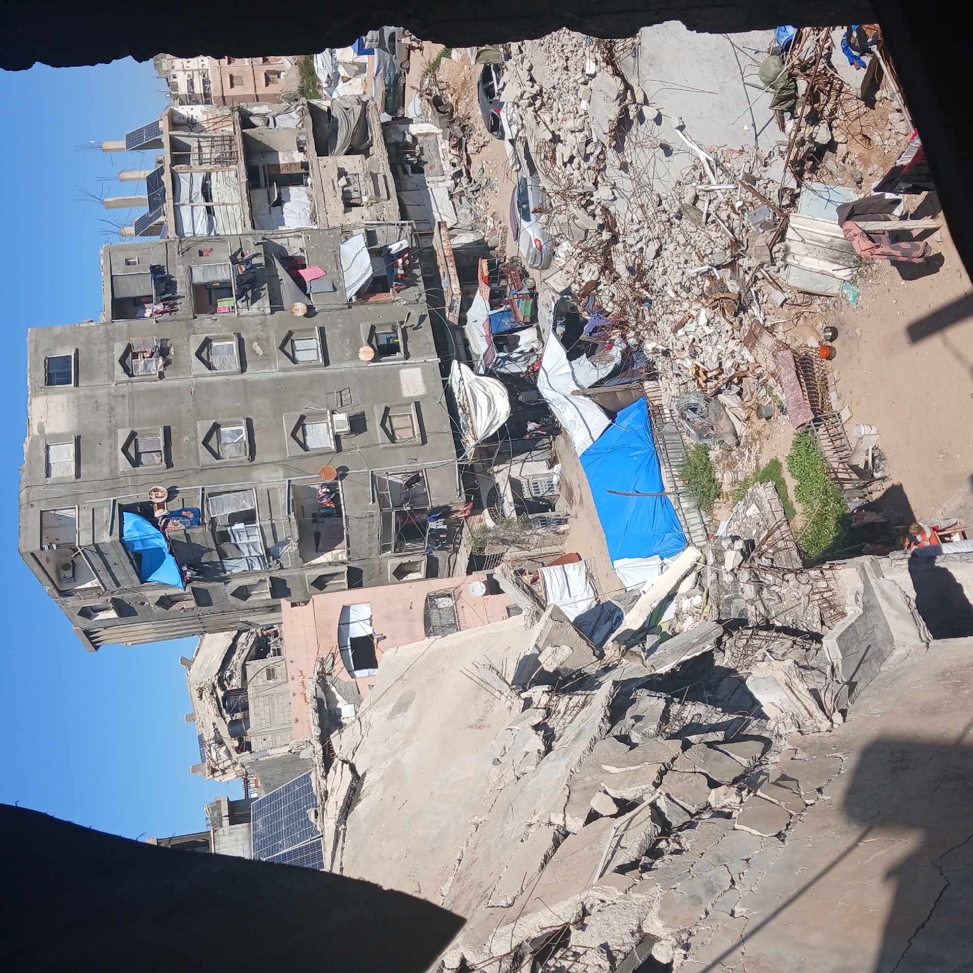 Outdoor cooking documented amid damaged buildings in Gaza City