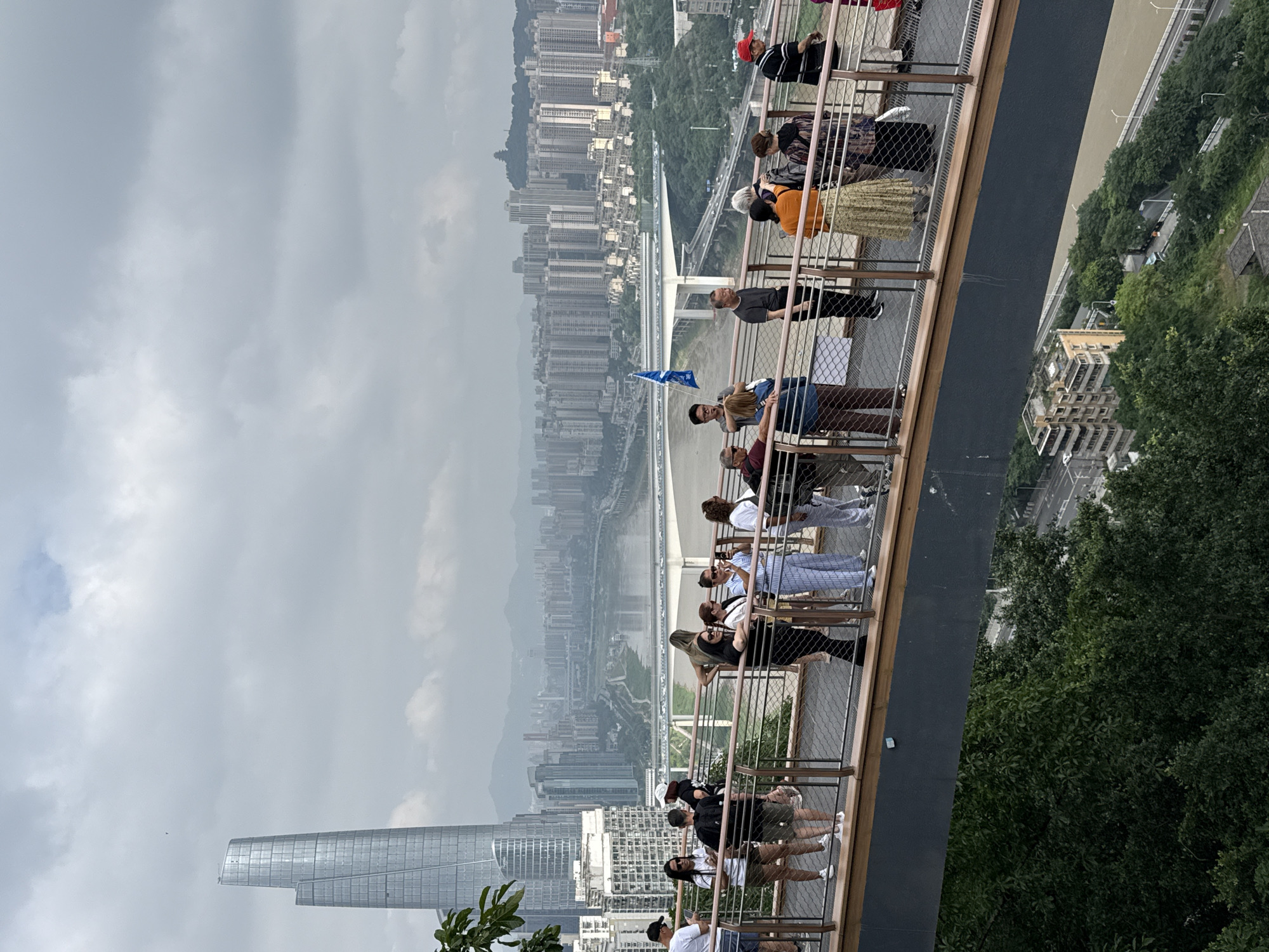 Late-night gathering on pedestrian bridge overlooks Yuzhong District skyline
