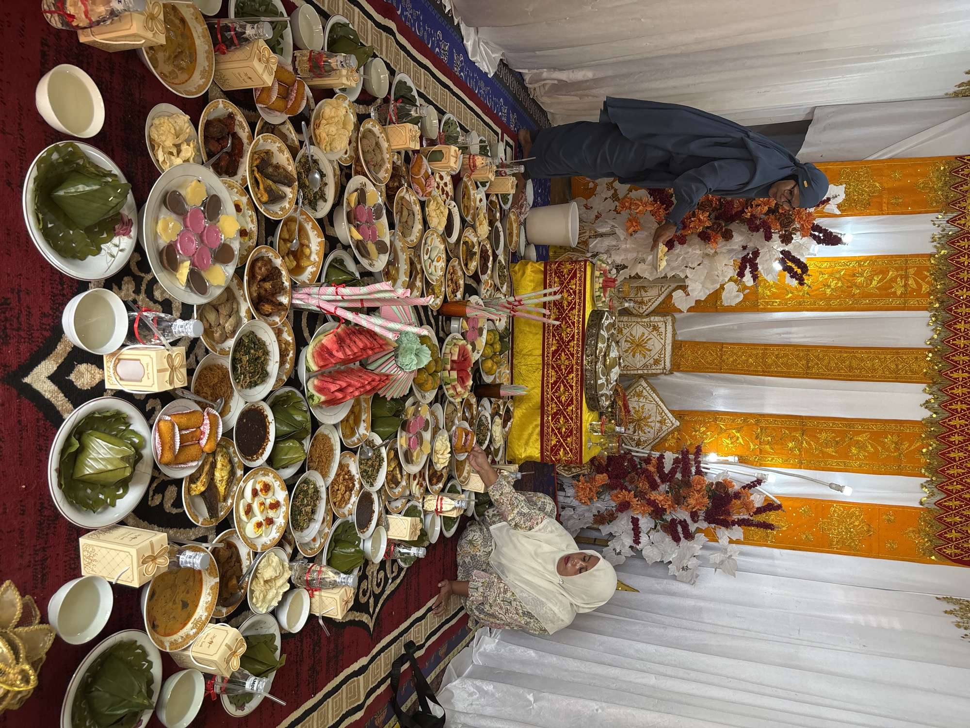 Traditional floor feast set up inside a decorated room in Indonesia