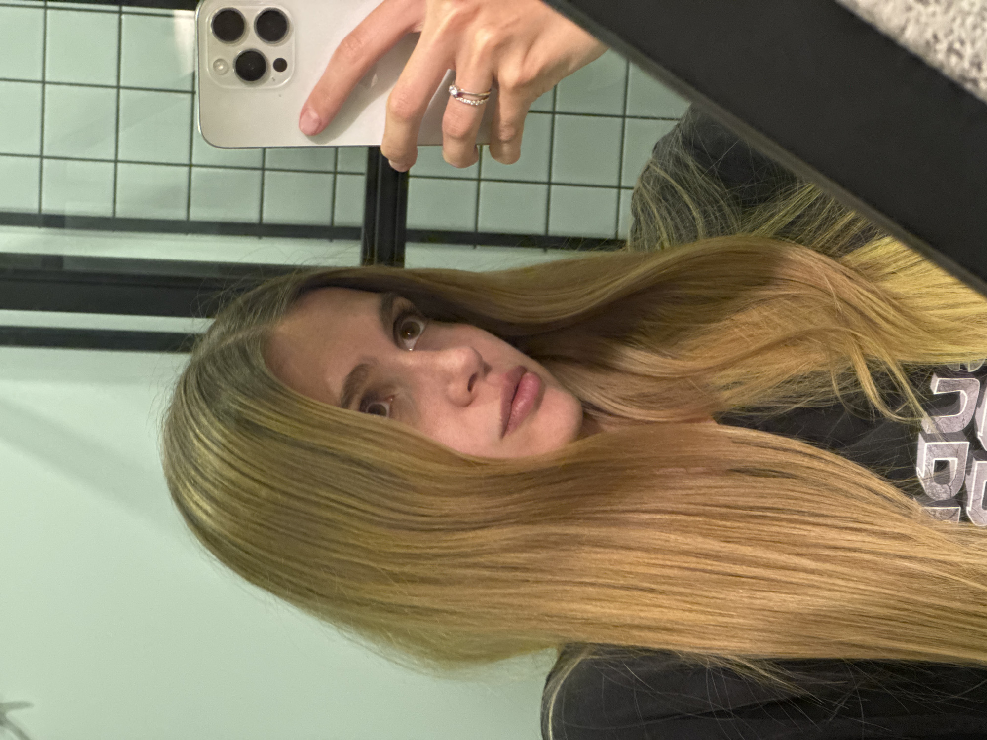 Woman takes bathroom mirror selfie in Tbilisi