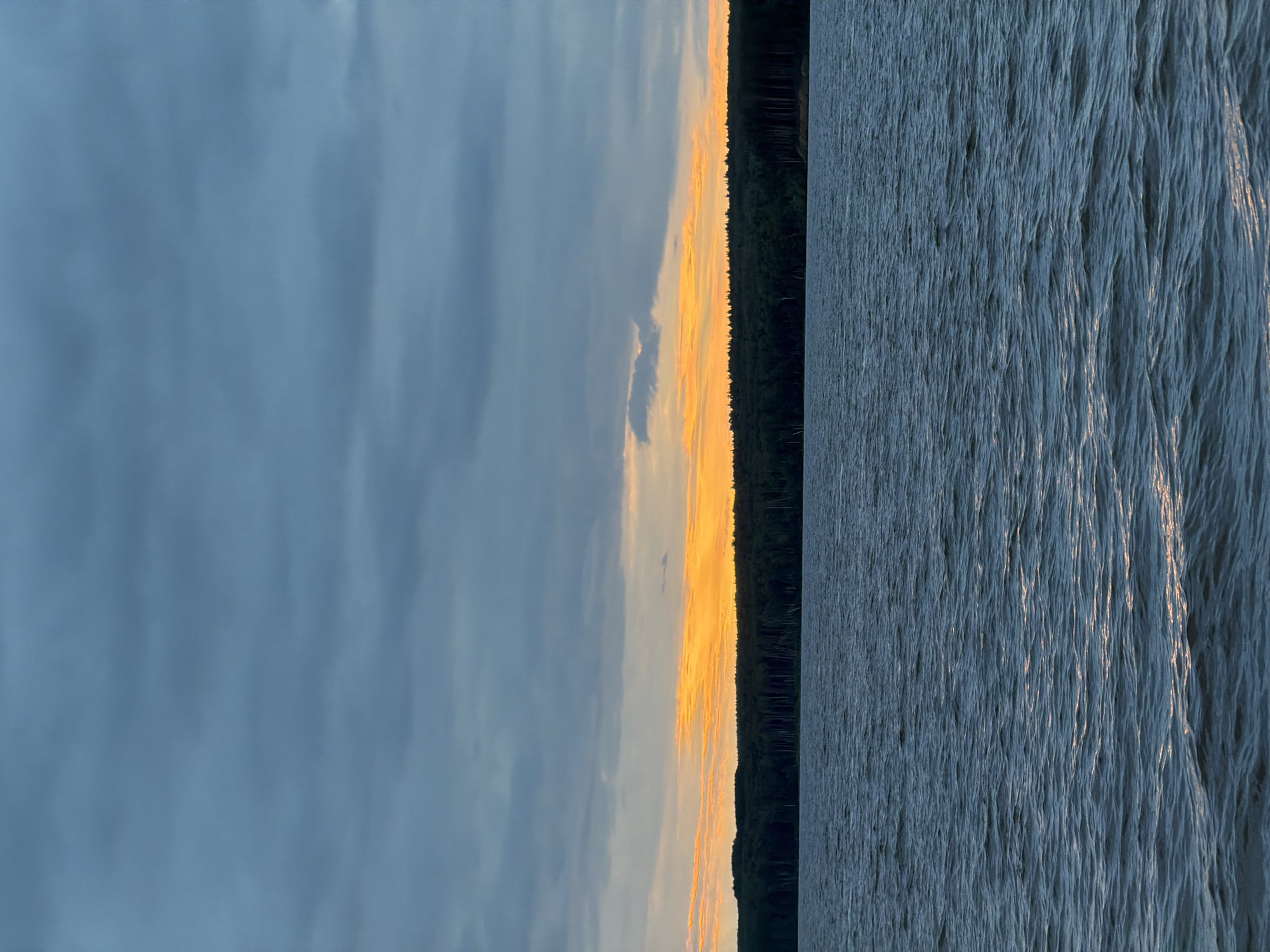 Man photographed during twilight fishing scene in Chaikovsky, Russia