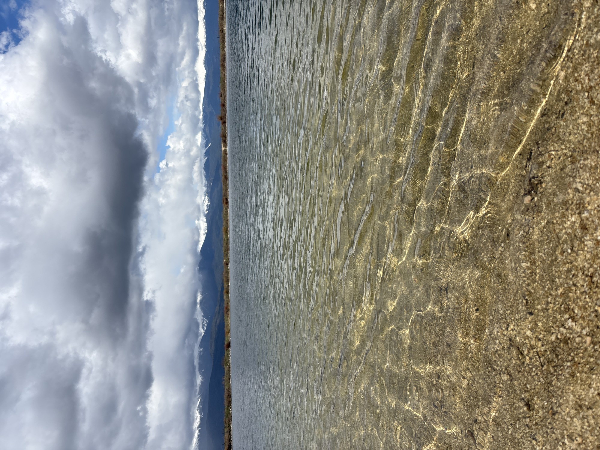 Person enjoys lakeside relaxation near Bansko mountain lake